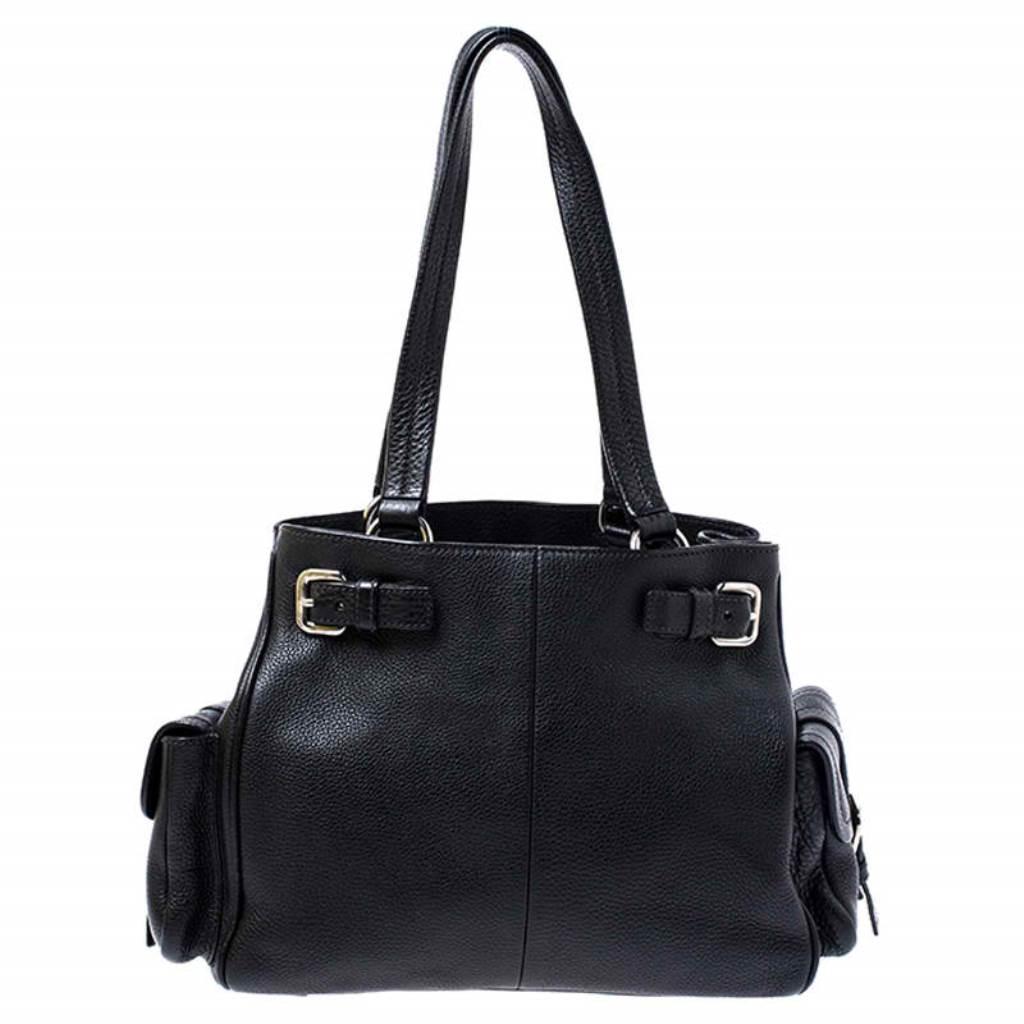 Look classy and sophisticated when you carry this Prada bag. Get yourself this stylish leather bag for a modern look. It is lined with nylon to store your essentials which adds to its functionality. The bag flaunts dual handles, side pockets and the