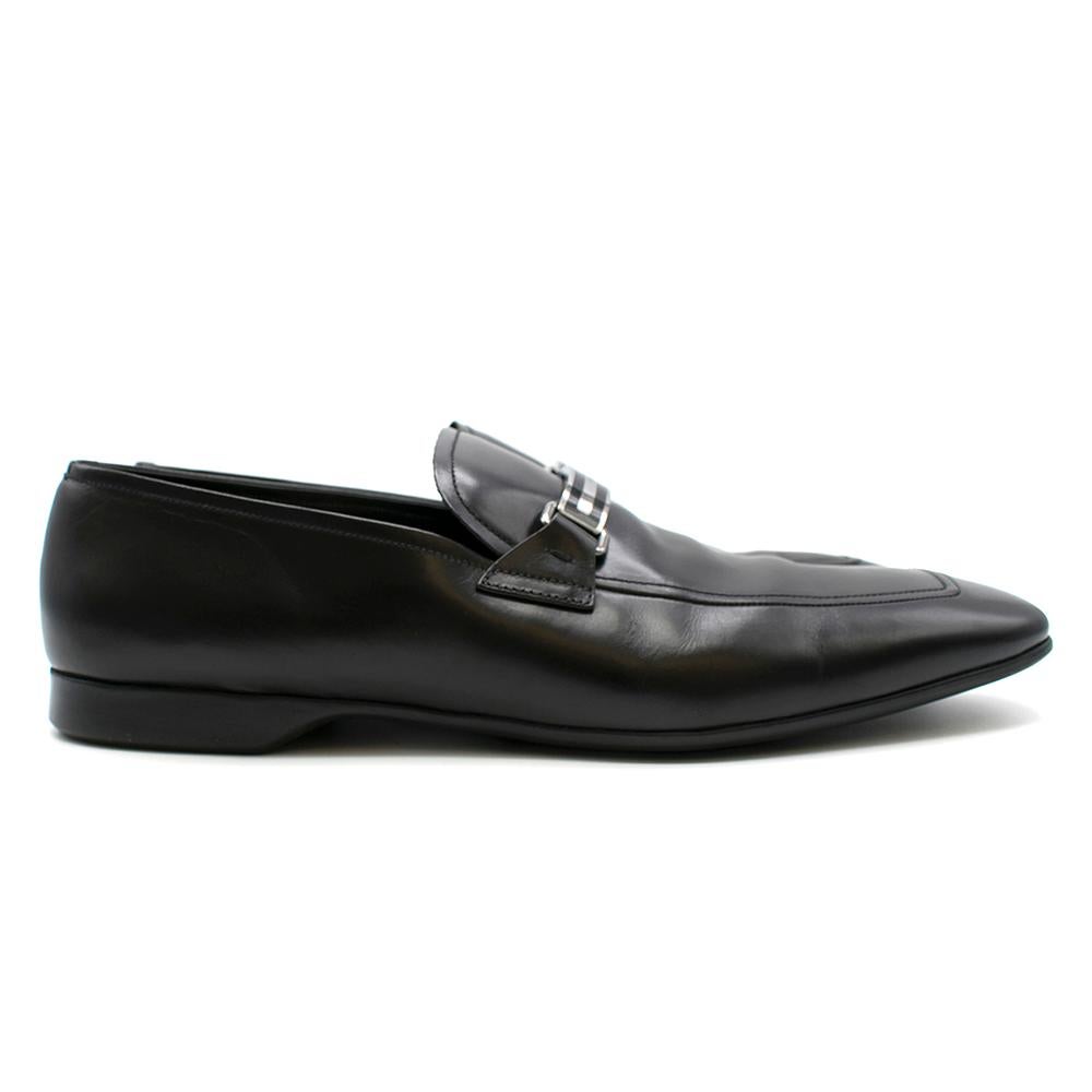 Prada Black Men's Leather Loafers 

Black leather loafers,
Silver and black Prada engraved metal on shoe exterior,
Leather insole

Dust bag included. 

Please note, these items are pre-owned and may show some signs of storage, even when unworn and