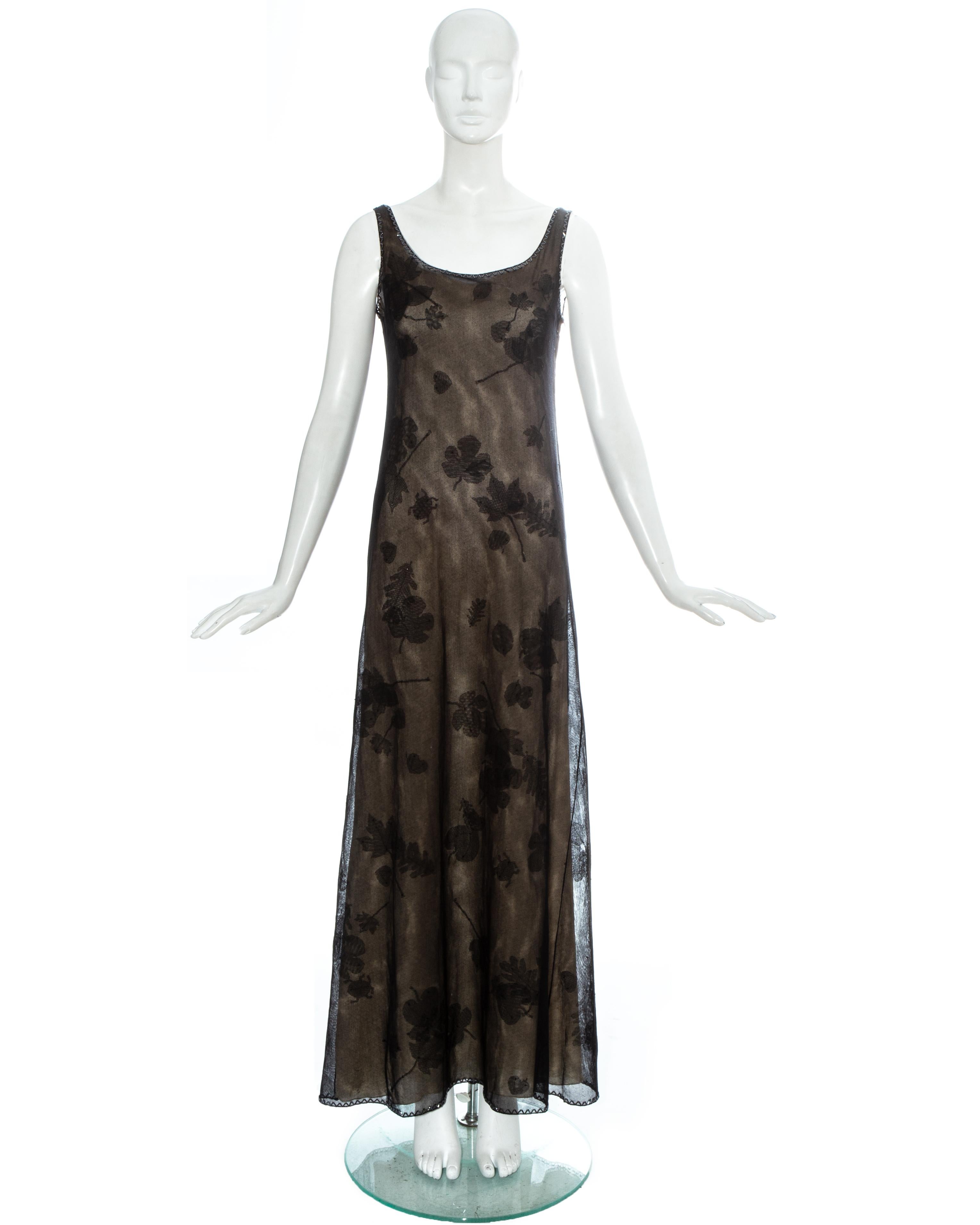 Prada black mesh evening maxi dress with beaded trim around collar and hem, appliquéd fabric leaves and detachable nude silk slip dress

Fall-Winter 1999