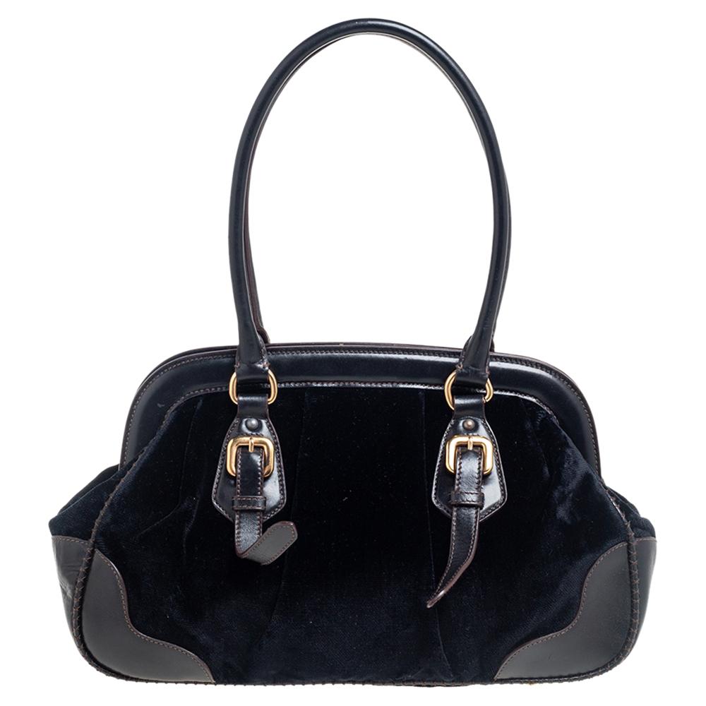 Giving handle bags an elegant update, this Frame bag by Prada will be a valuable addition to your closet. It has been crafted from leather and velvet. It comes with dual top handles, protective metal feet at the bottom, and a perfectly sized nylon