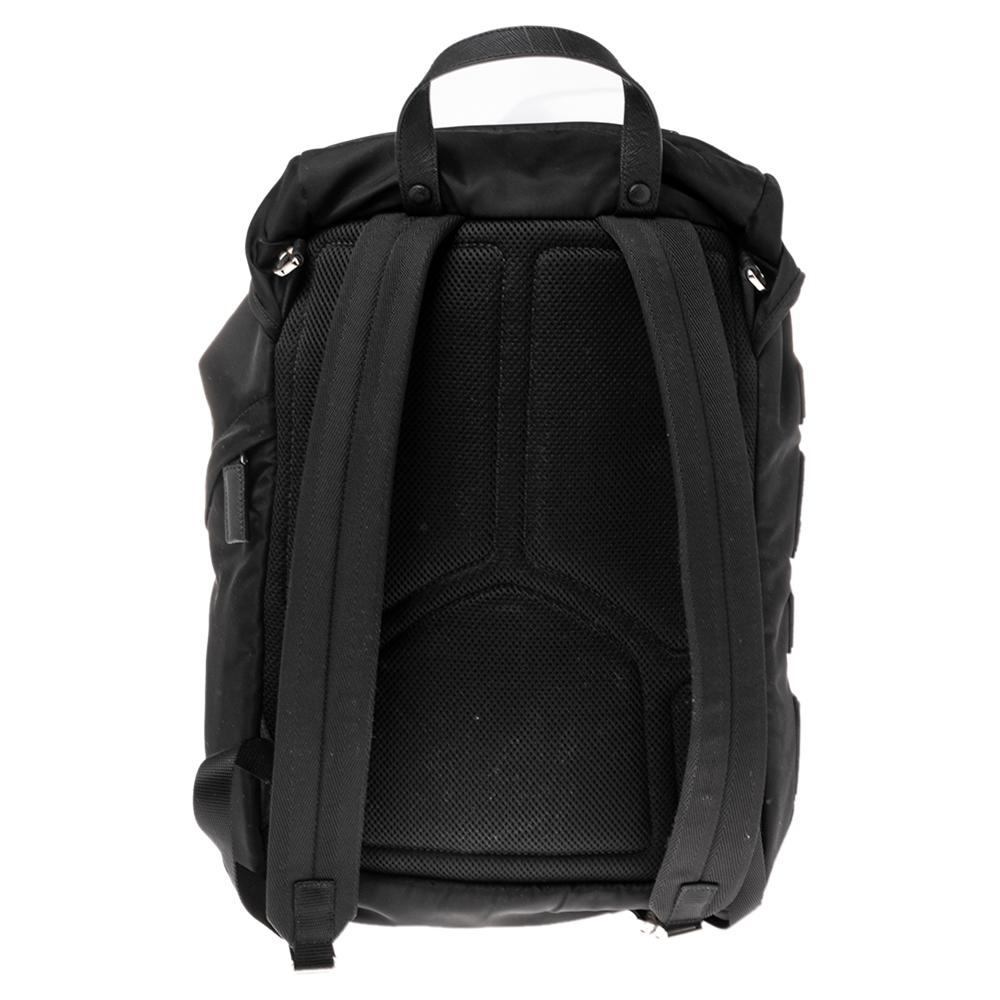 Maximize your comfort and increase your style quotient when you carry this backpack made by Prada. Black nylon and leather are utilized to create this backpack externally. It is super sturdy in structure and measures 26 x 14 x 44 cm in size. With