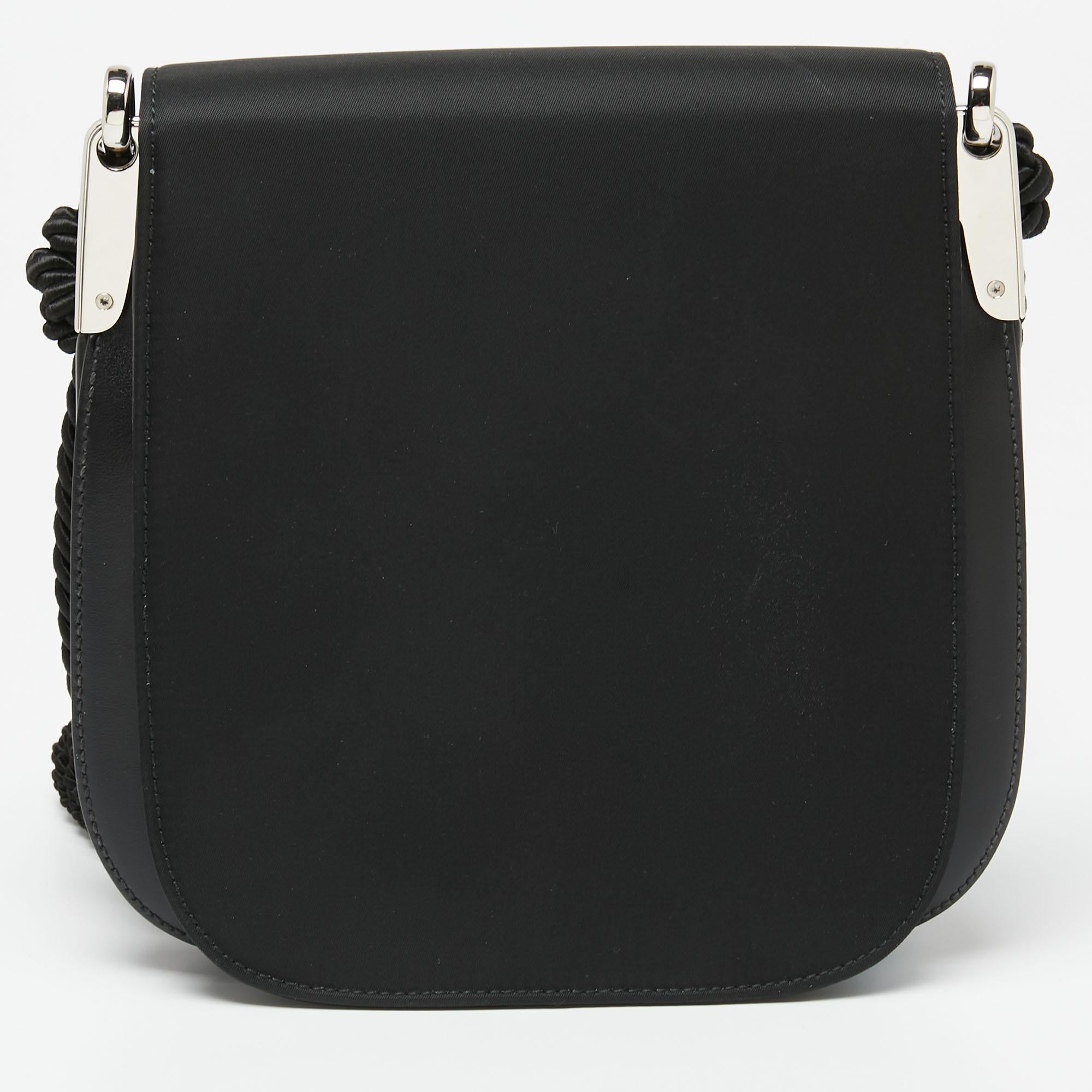 A shoulder bag from Prada is just what you need in your closet. This black bag here comes crafted from fine materials and has a beautiful tassel detail on the front and on the strap. It will effortlessly match all your casual outfits.

Includes: