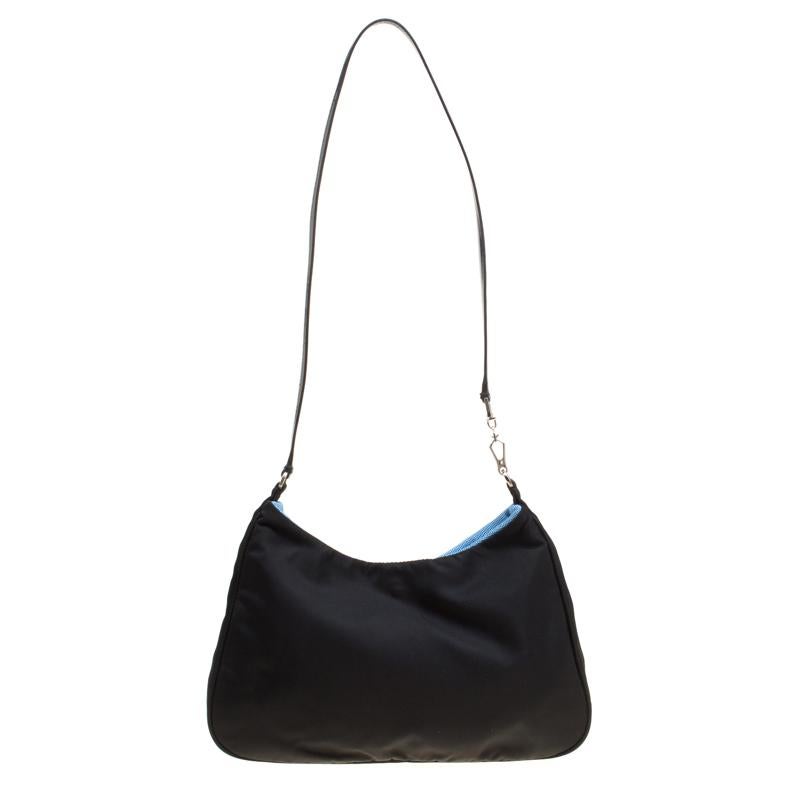 Simple and sophisticated is what defines this lovely bag from Prada. The black bag is crafted from nylon and patent leather and features the brand logo at the front. It flaunts a single shoulder strap and opens to a spacious nylon lined interior