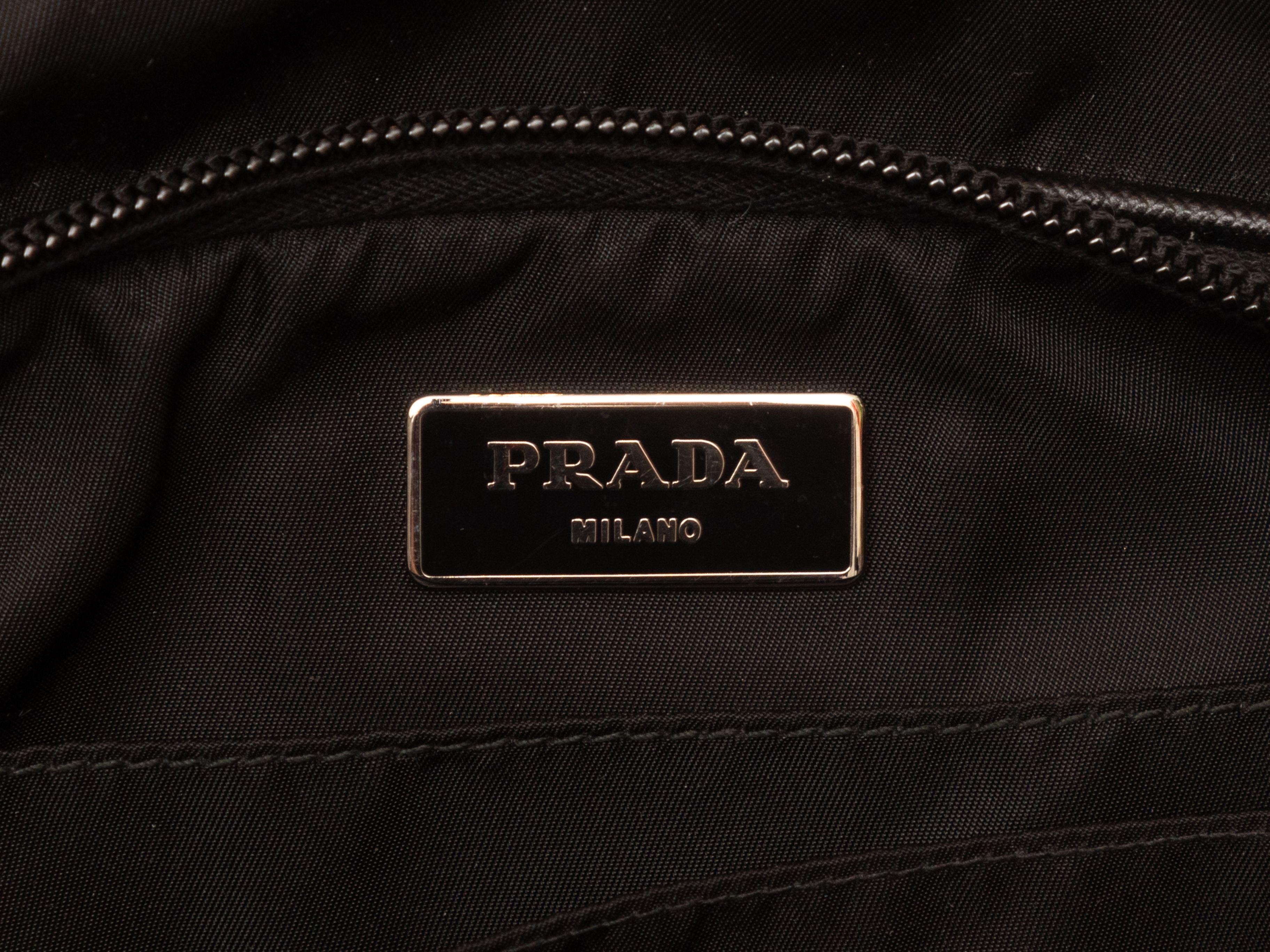 Product Details: Black Prada Nylon Travel Bag. This bag features a nylon body, silver-tone hardware, dual top handles, a front zip closure pocket, optional flat shoulder strap, and a top zip closure. 15