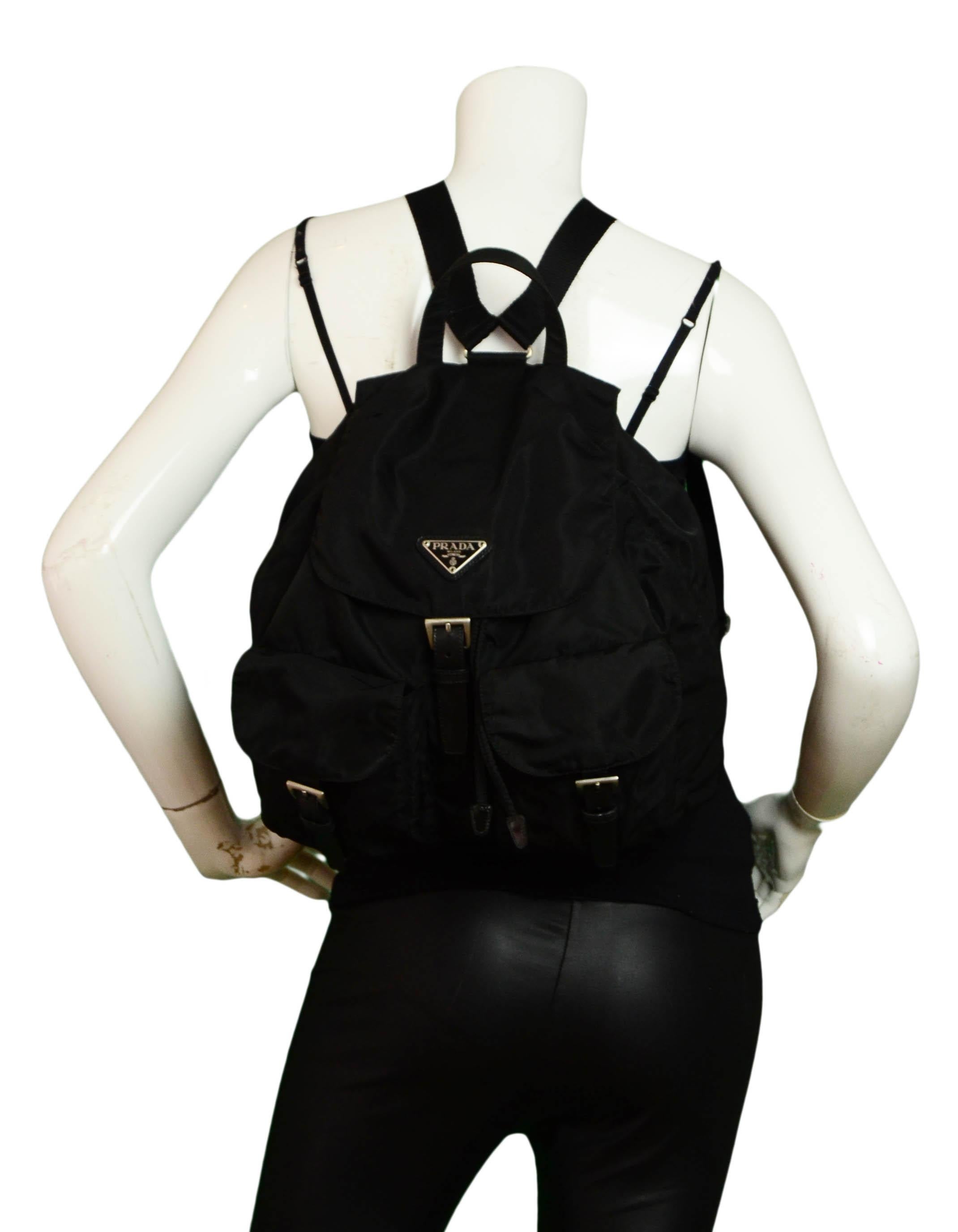 Prada Black Nylon Double Pocket Backpack Bag

Made In: Italy
Year of Production: Vintage
Color: Black
Hardware: Silvertone
Materials: Nylon & leather
Lining: Textile
Closure/Opening: Drawstring & magnetic snap w/ buckle
Exterior Pockets: Two snap &