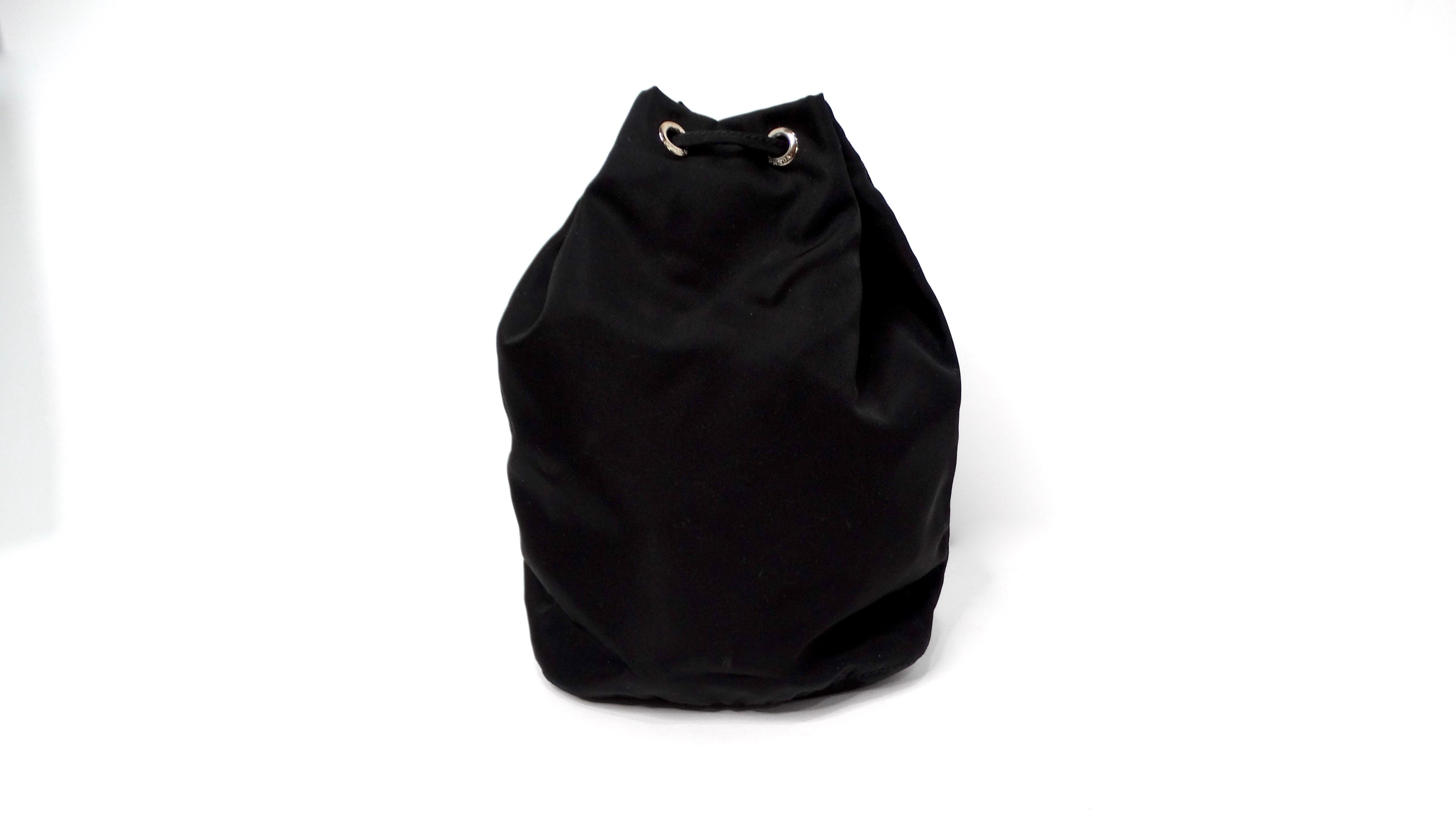 The Prada Black Nylon Drawstring Mini Pouch is a perfect embodiment of modern luxury and functional design. Made from high-quality nylon, this sleek mini pouch is lightweight yet durable, showcasing a minimalist aesthetic that complements any
