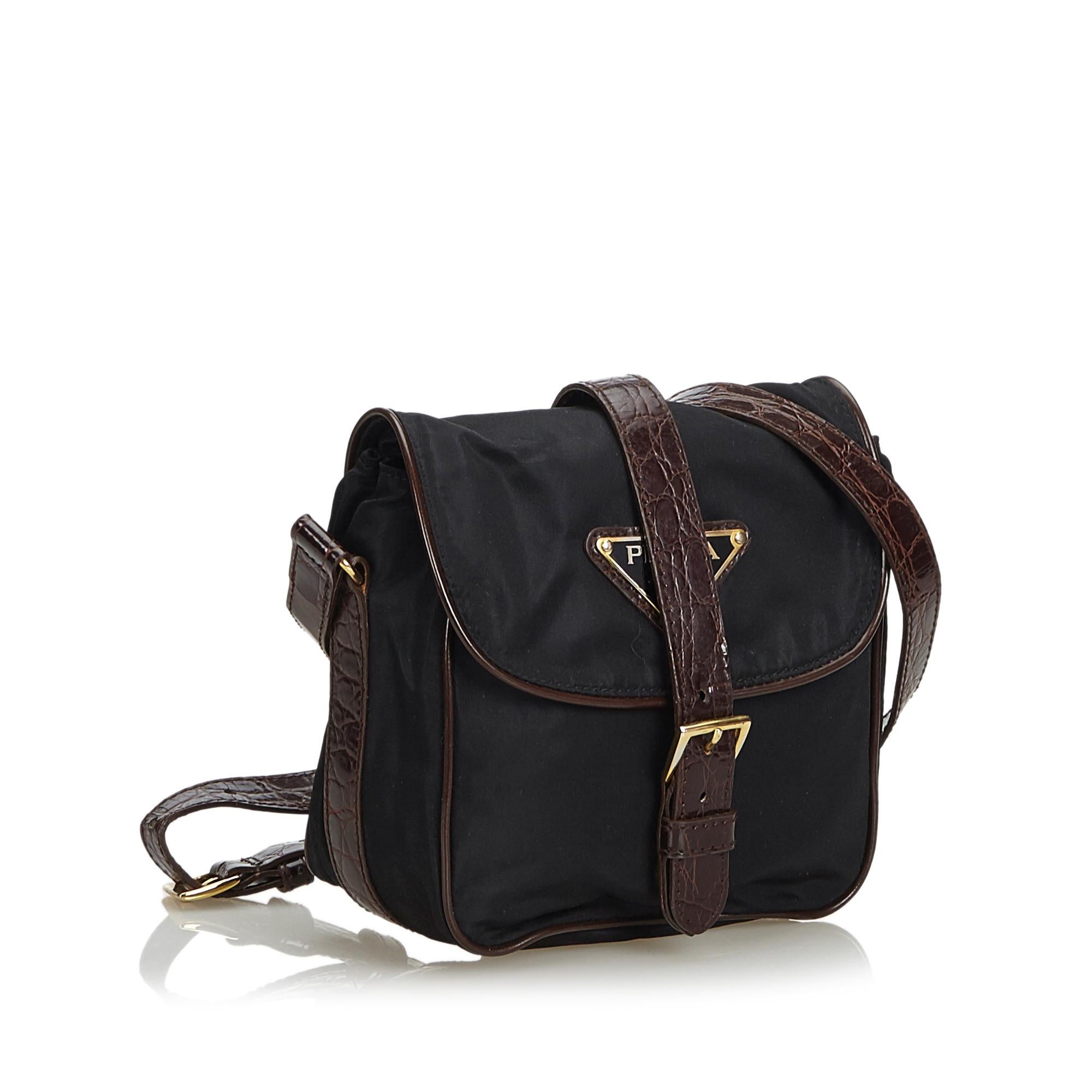 This crossbody bag features a nylon body, a flat leather strap, a front flap with a leather top buckle strap, and an interior zip pocket. It carries as B+ condition rating.

Inclusions: 
This item does not come with inclusions.

Dimensions:
Length:
