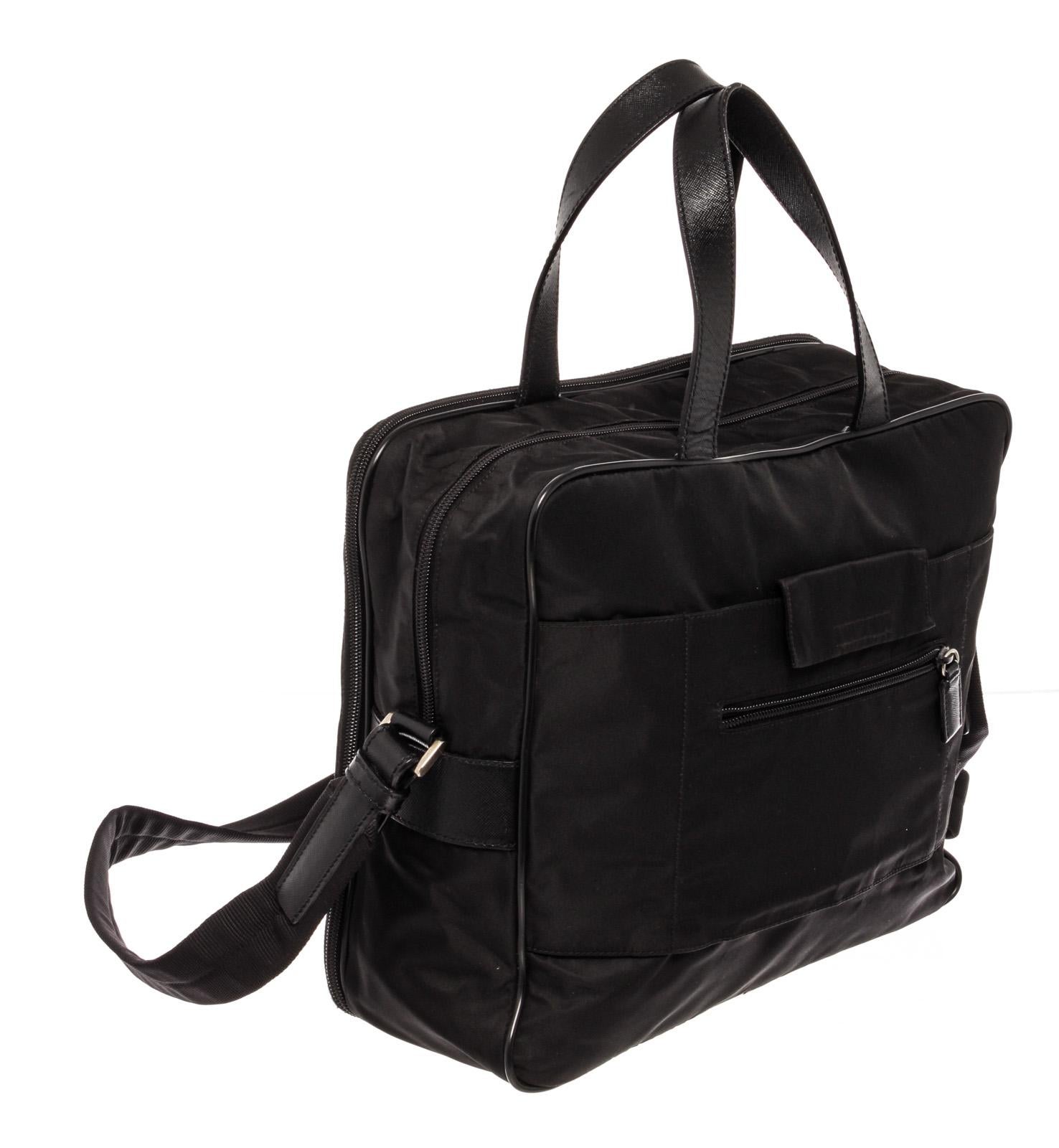 Prada Black Nylon Leather Messenger Bag with leather, gold-tone hardware, trim leather, interior slip pocket, dual top handle, shoulder strap and zipper closure.

61228MSC