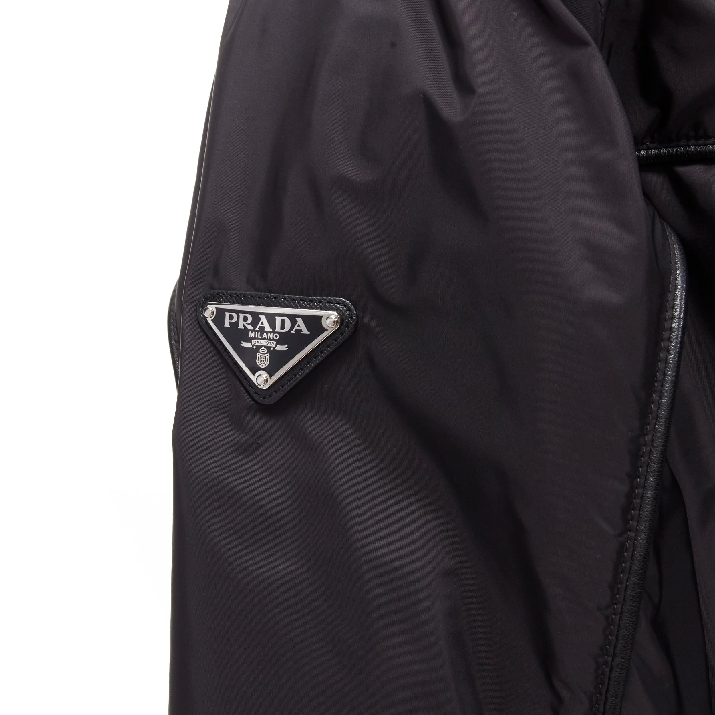 PRADA black nylon leather piping trim triangle seal windbreaker hooded jacket M 
Reference: AEMA/A00047 
Brand: Prada 
Designer: Miuccia Prada 
Collection: 2016 
Material: Nylon 
Color: Black 
Pattern: Solid 
Closure: Zip 
Extra Detail: Black nylon