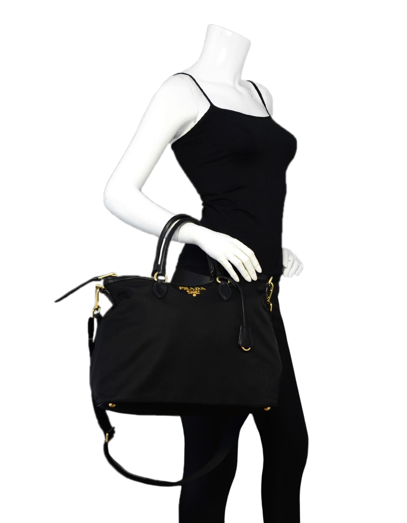 Prada Black Nylon/Leather Zip Top Tote Bag

Color: Black
Hardware: Goldtone
Materials: Nylon, leather trim
Lining: Black textile lining
Closure/Opening: Top zip
Exterior Pockets: N/A
Interior Pockets: One zipper pocket, one slit pocket
Exterior