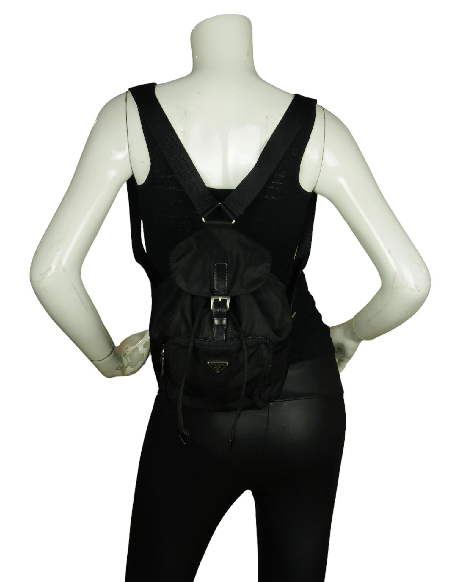 Prada Black Nylon Mini Backpack Bag w/ Front Pocket

Made In: Italy
Color: Black
Hardware: Silvertone
Materials: Nylon with leather trim 
Lining: Prada fine textile
Closure/Opening: Flap top with drawstring and buckle
Exterior Pockets: One front