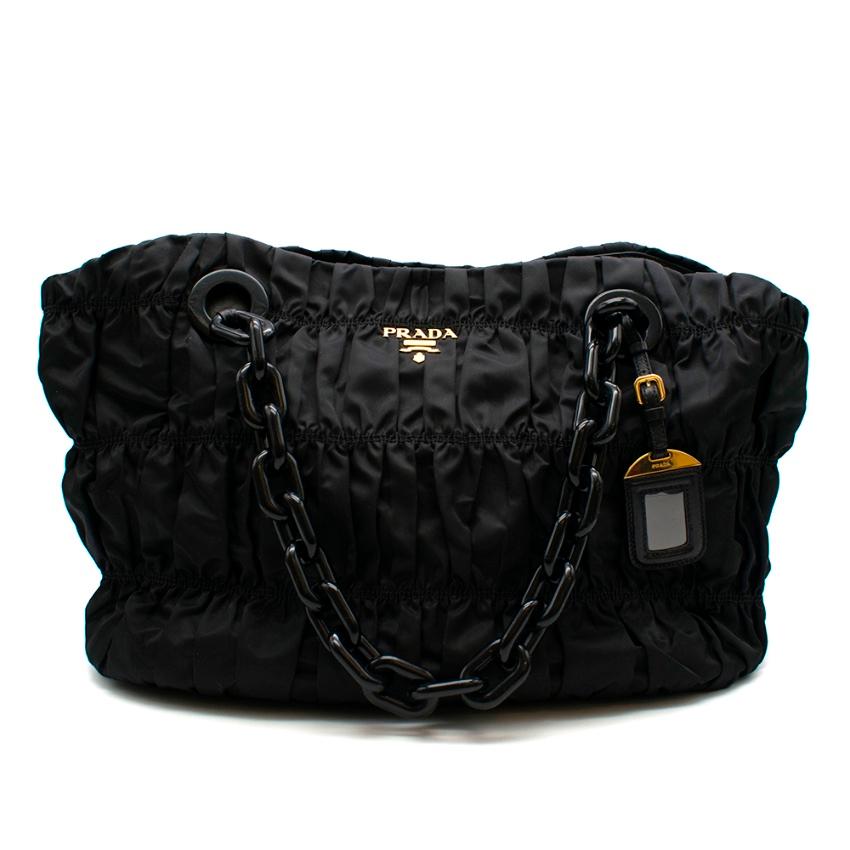Prada Black Nylon Quilted Tote Shoulder Bag 

- Large Chain Handles 
- Gold toen hardware 
- logo detail on front 
- quilted style throughout 
- name tag 
- Two internal zip pockets 
- Magnetic clasp closure 

Please note, these items are pre-owned