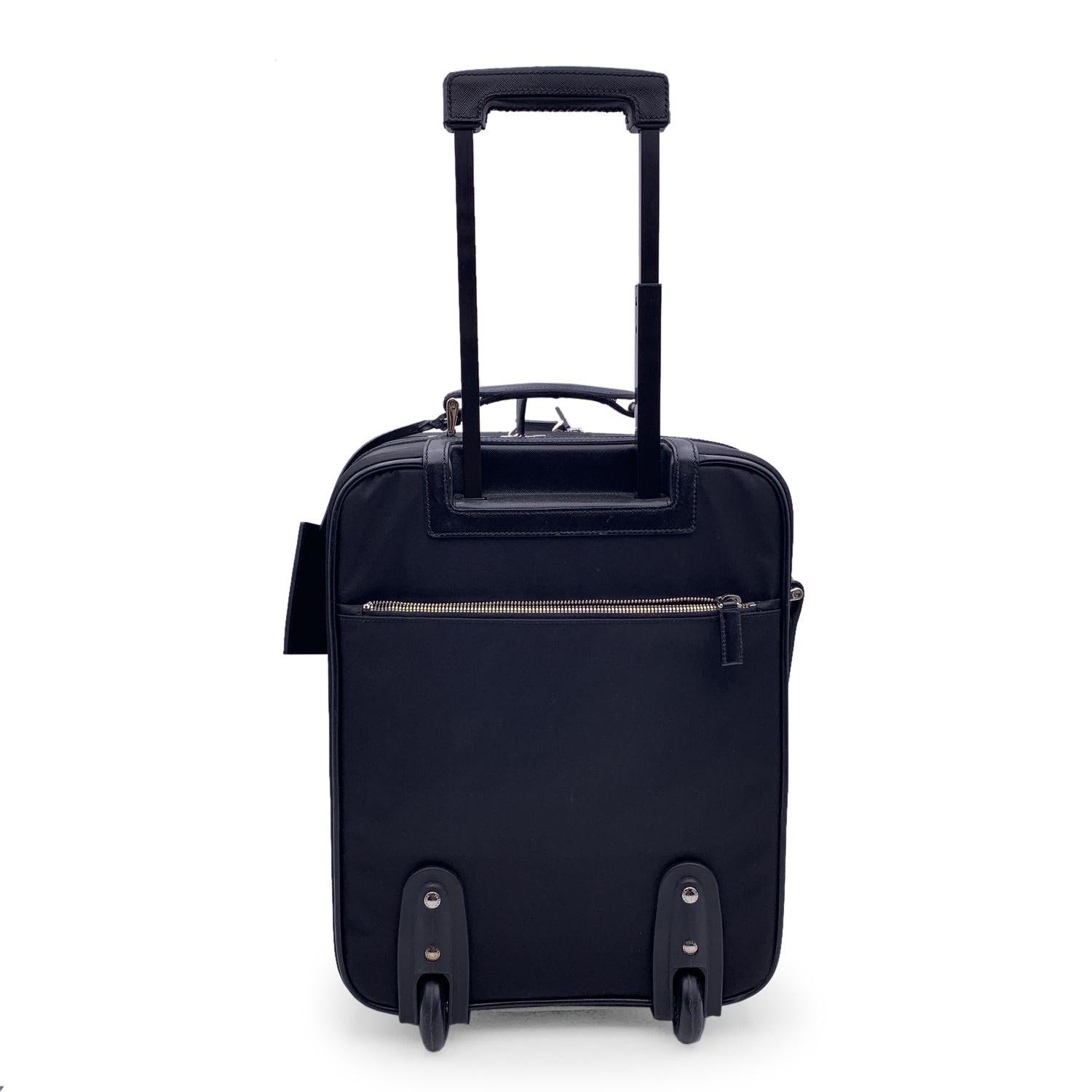 This beautiful Bag will come with a Certificate of Authenticity provided by Entrupy. The certificate will be provided at no further cost. Gorgeous Prada Rolling Luggage Trolley travel bag. Black nylon, saffiano leather trim and fabric lining. Prada