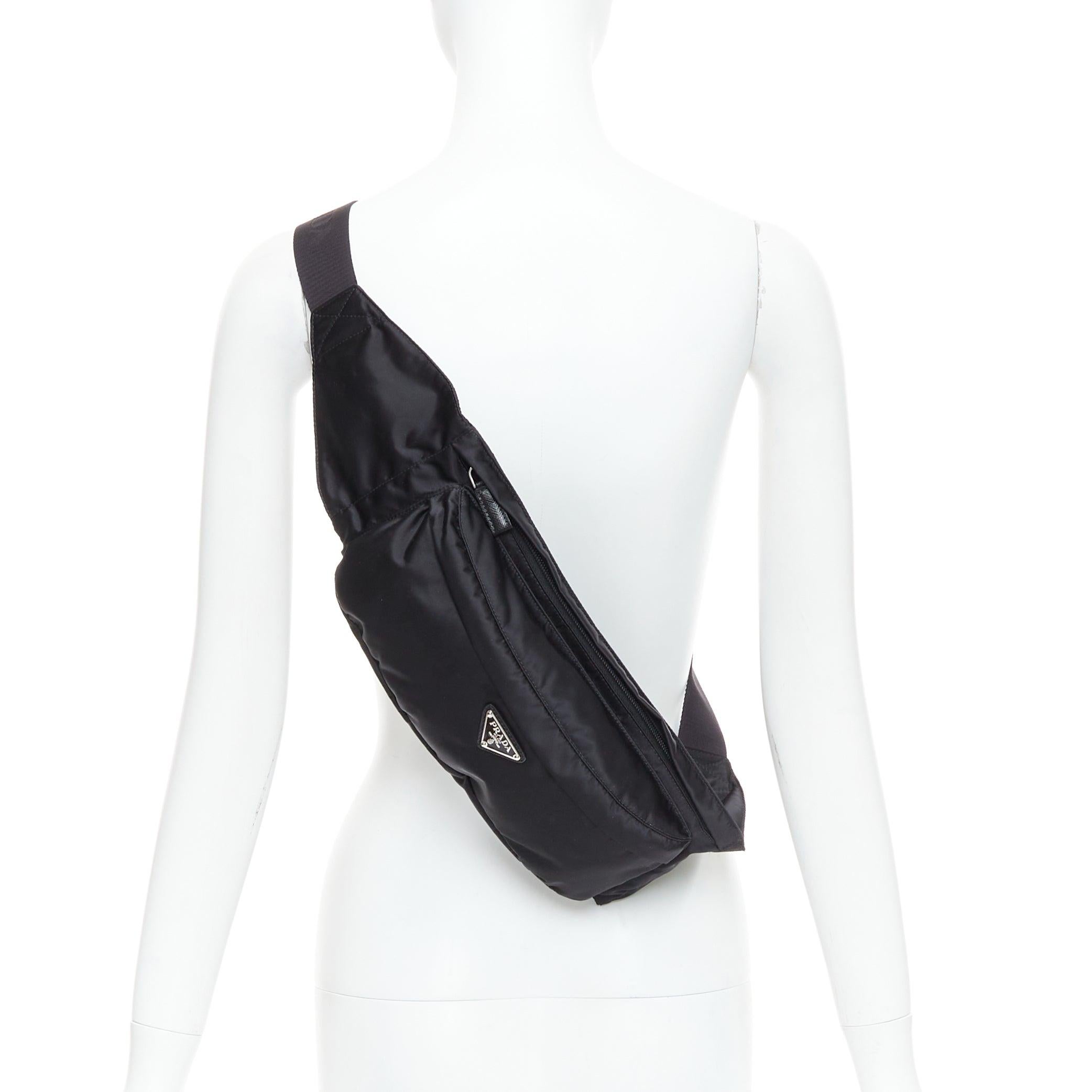 PRADA black nylon silver logo triangle buckle belt bag
Reference: CNLE/A00334
Brand: Prada
Designer: Miuccia Prada
Material: Nylon
Color: Black, Silver
Pattern: Solid
Closure: Zip
Lining: Black Fabric
Extra Details: Combining a functional hands-free