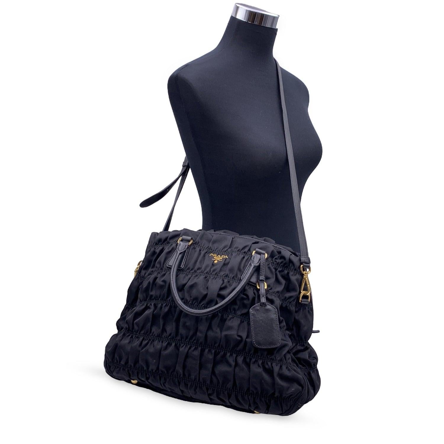 This beautiful Bag will come with a Certificate of Authenticity provided by Entrupy. The certificate will be provided at no further cost Elegant Prada Tessuto Gauffre Tote bag. The bag is crafted of black draped nylon with black leather trim,