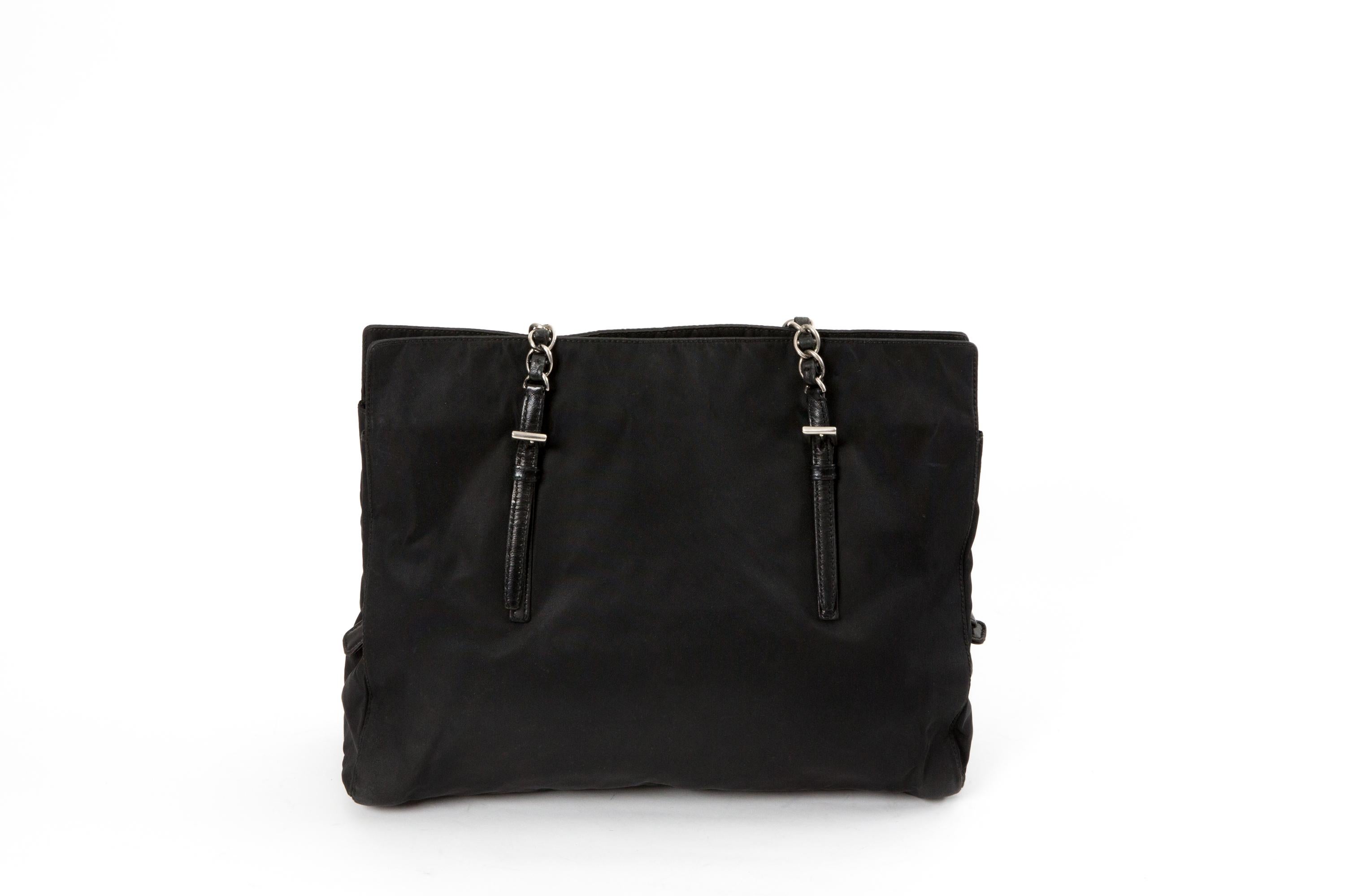 Prada Nylon Tessuto Tote Bag featuring the enameled metal triangle logo on the front, top silver tone chain and leather handles 33.5in. (85cm), a compartment with top zipper closure and interior logo lining, a compartment with top zipper. 
100%