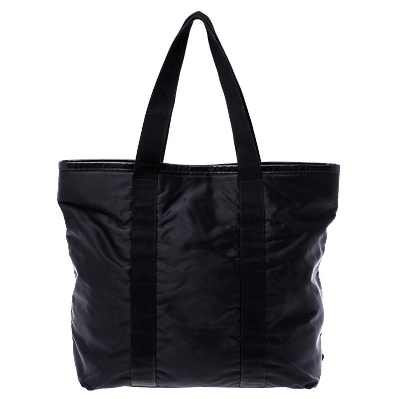 This enchanting and beautifully shaped nylon handbag by Prada is a must-have. The plush and durable nylon lining of the bag helps you accommodate all your essentials safely. This outstanding black tote will go well with almost all your outfits. The