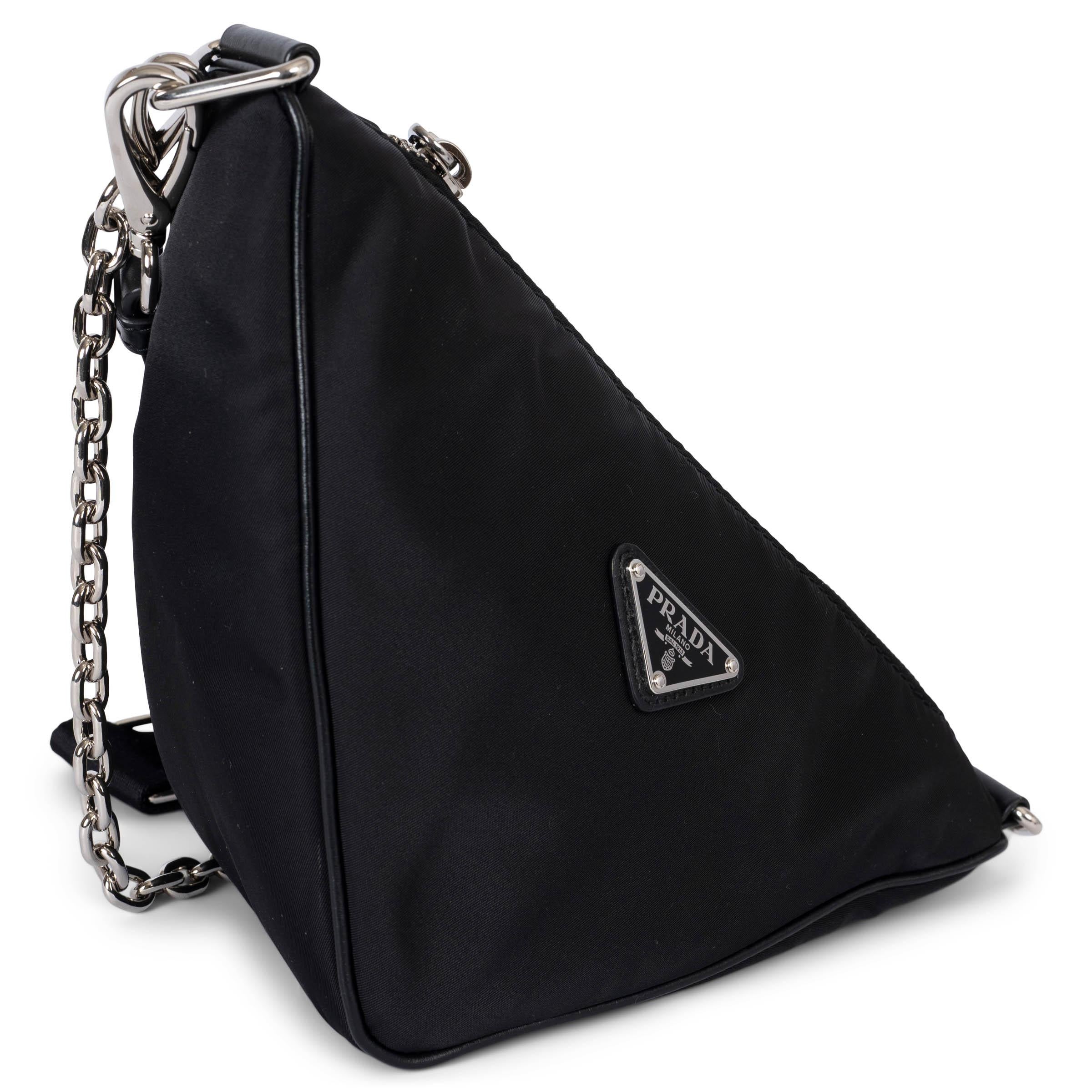 100% authentic Prada Triangle crossbody bag in black Re-nylon. Features black leather trims, a shorter detachable chain strap and a longer adjustable and detachable canvas strap with detachable zip pouch. Closes with a zipper on top and is lined in