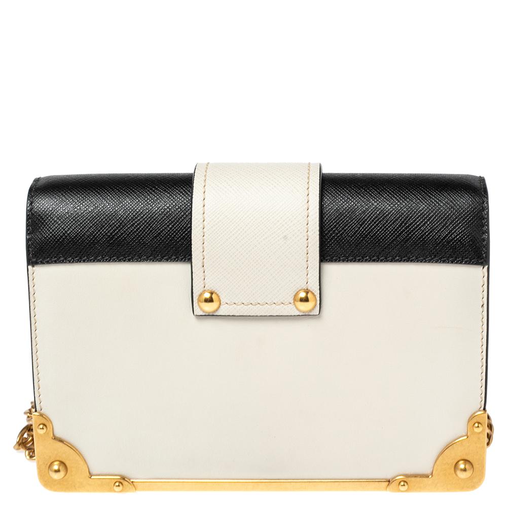 Impeccably designed in Saffiano leather, this Cahier crossbody bag by Prada is the perfect one for the modern fashionista. Lined with fine leather, this off-white bag delivers trendy looks as well as functionality. It has a front adorned with