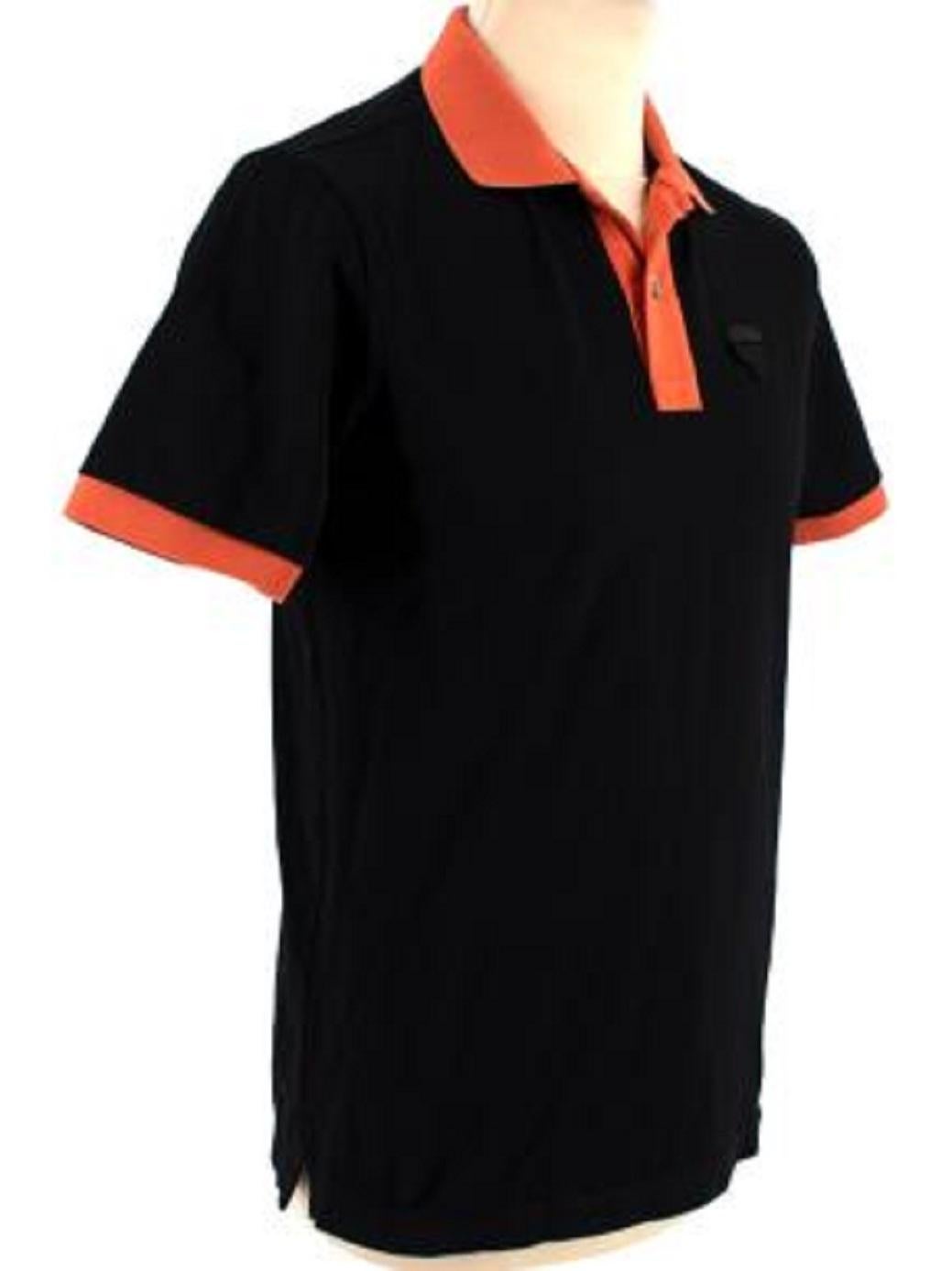Prada Black & Orange Cotton Polo Shirt

- Two-button fastening
- Logo patch on chest
- Orange collar and cuffs
- Ribbed collar and cuffs

Material
100% Cotton

Made in Romania

9.5/10 Excellent condition

PLEASE NOTE, THESE ITEMS ARE PRE-OWNED AND