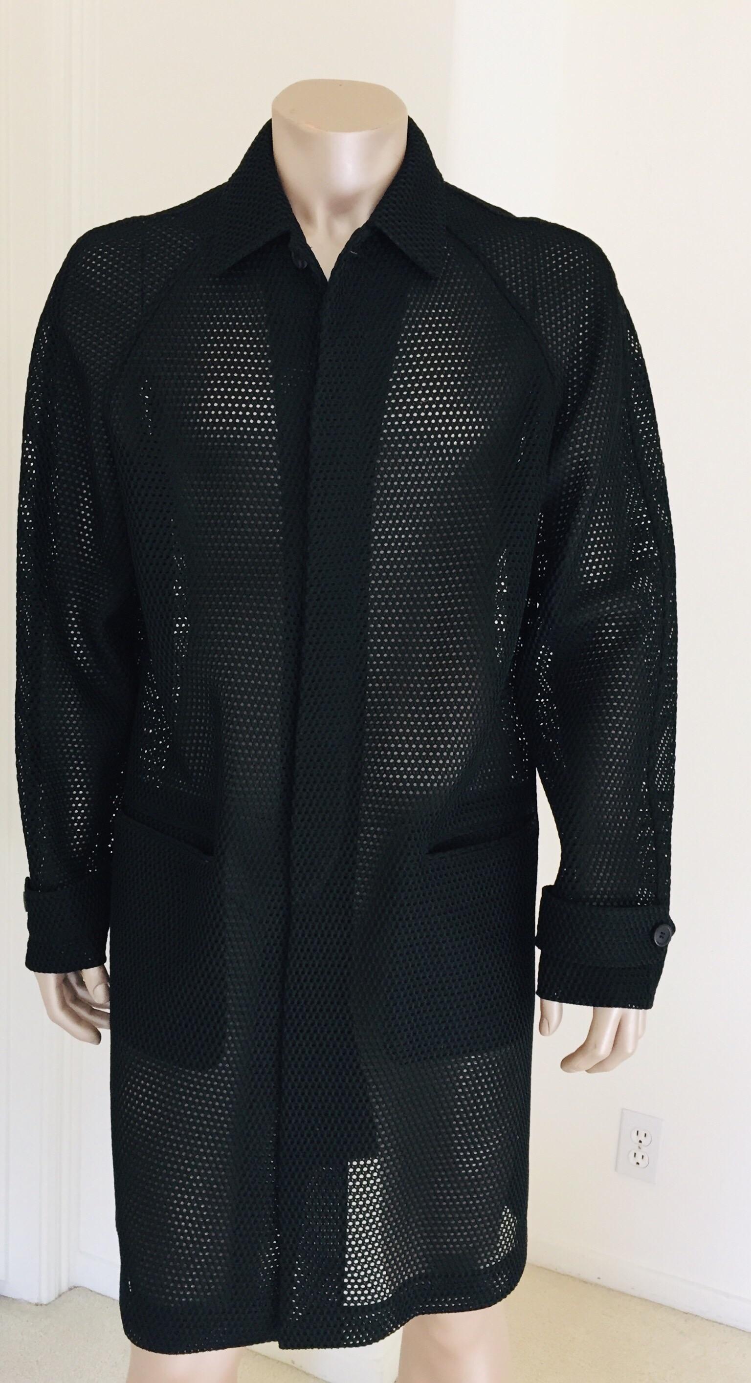 Prada black overcoat.
Flap pockets on the side
Adjustable straps on the cuffs
Light summery overcoat, see through lace.
Size 52.
Garment length: 44 inches.
Made in Italy.
Like new.
Prada Milano black label.