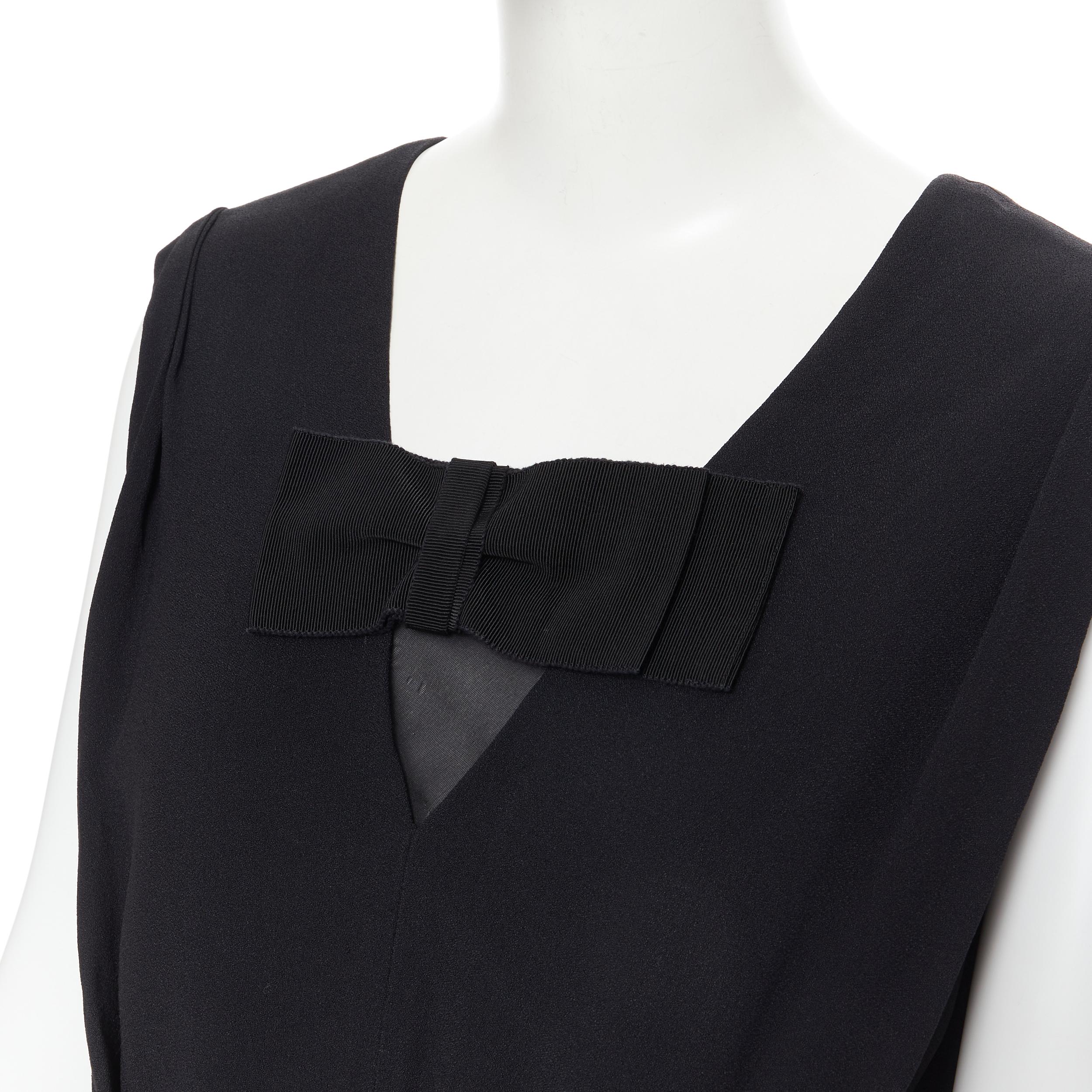 PRADA black oversized grosgrain bow pleated front sheath dress IT42 M 
Reference: PYCN/A00072 
Brand: Prada 
Designer: Miuccia Prada 
Material: Acetate 
Color: Black 
Pattern: Solid 
Closure: Zip 
Extra Detail: V-neck with grosgrain bow detail.