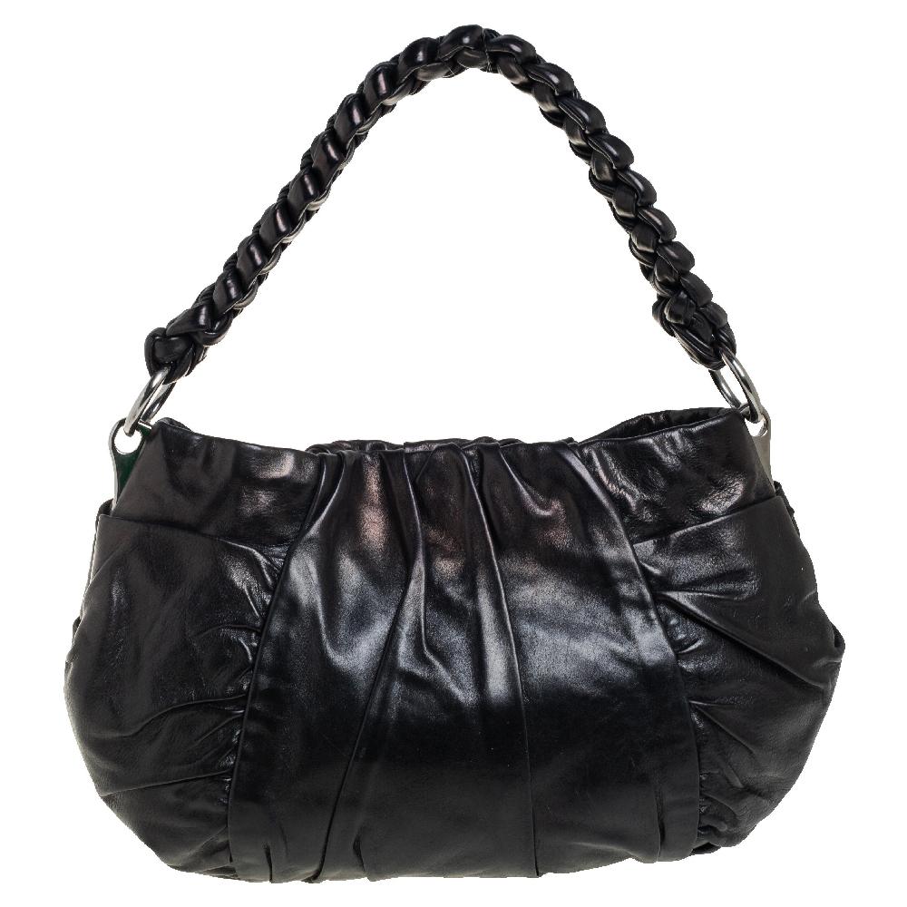 A hobo as lovely as this one from Prada surely deserves to be in every woman's closet. It is made from black patent leather and it comes with a snap button that opens to a well-sized fabric interior. A braided handle beautifully completes this