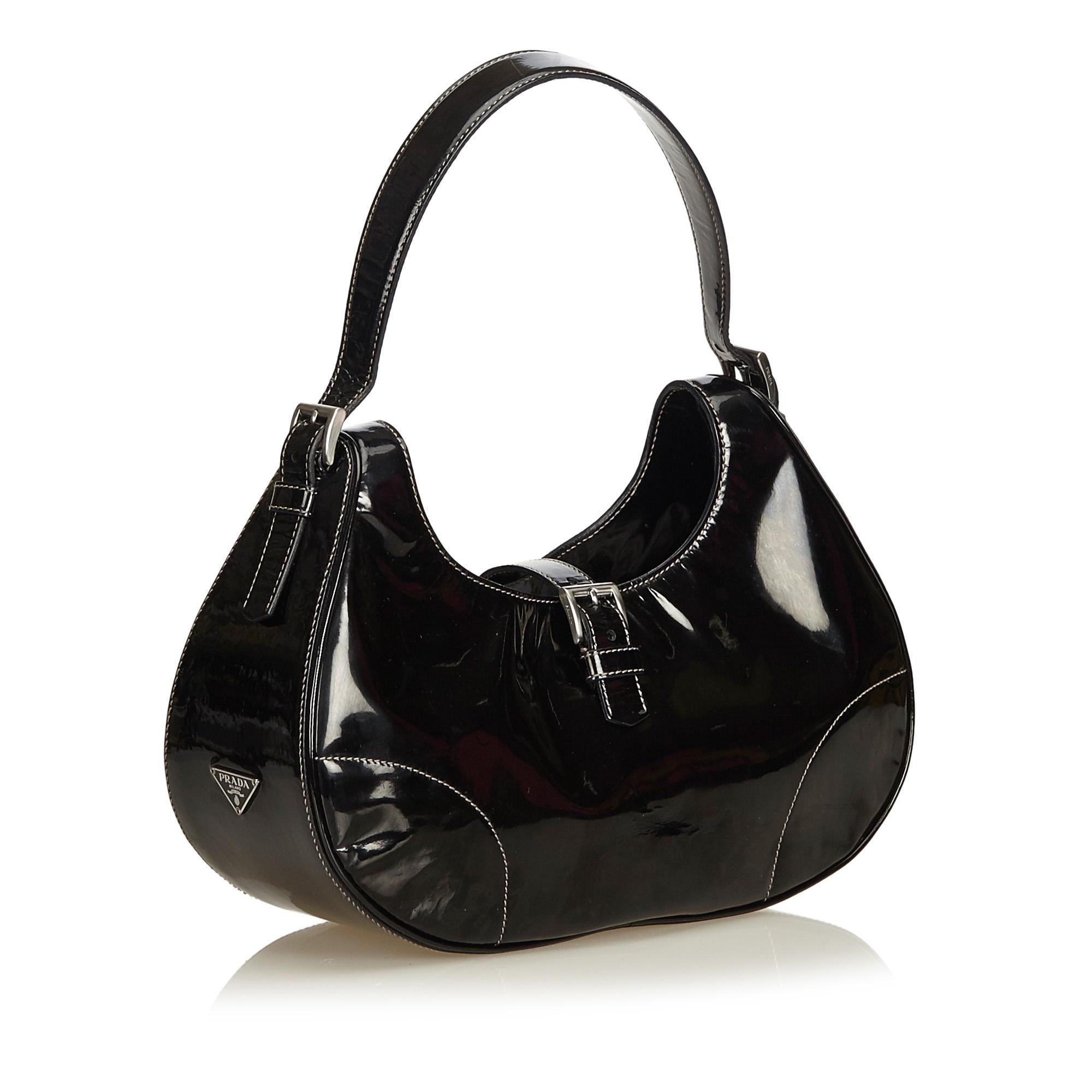 This hobo bag features a leather body, adjustable leather handle, open top with front strap and belt buckle closure, and an interior zip pocket. It carries as AB condition rating.

Inclusions: 
This item does not come with