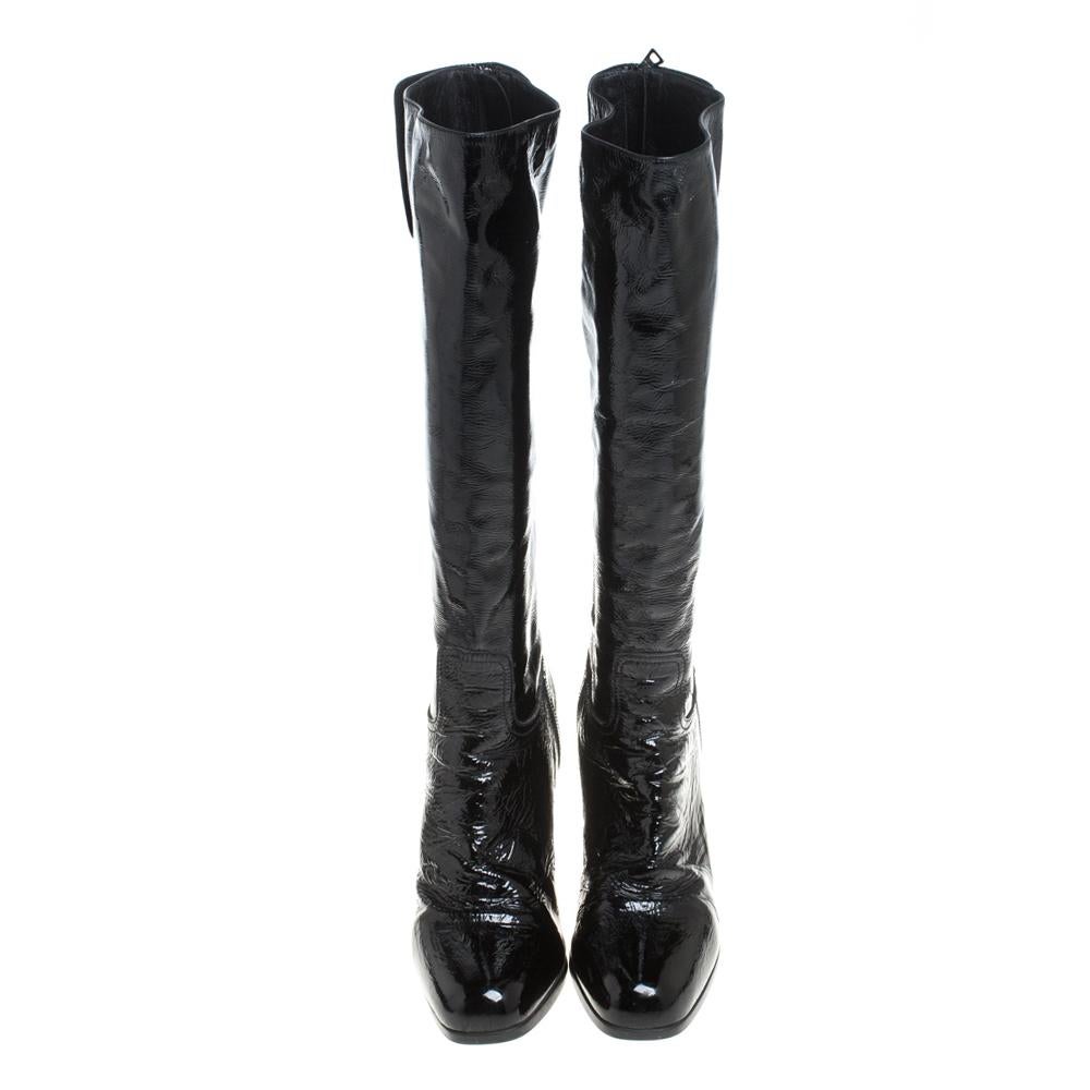 Prada never fails to design fashion-forward styles that are suitable for every occasion. These black knee-length boots for women are a fine example. Made from patent leather, they feature platforms, back zip closure, and 9.5 cm high heels.

