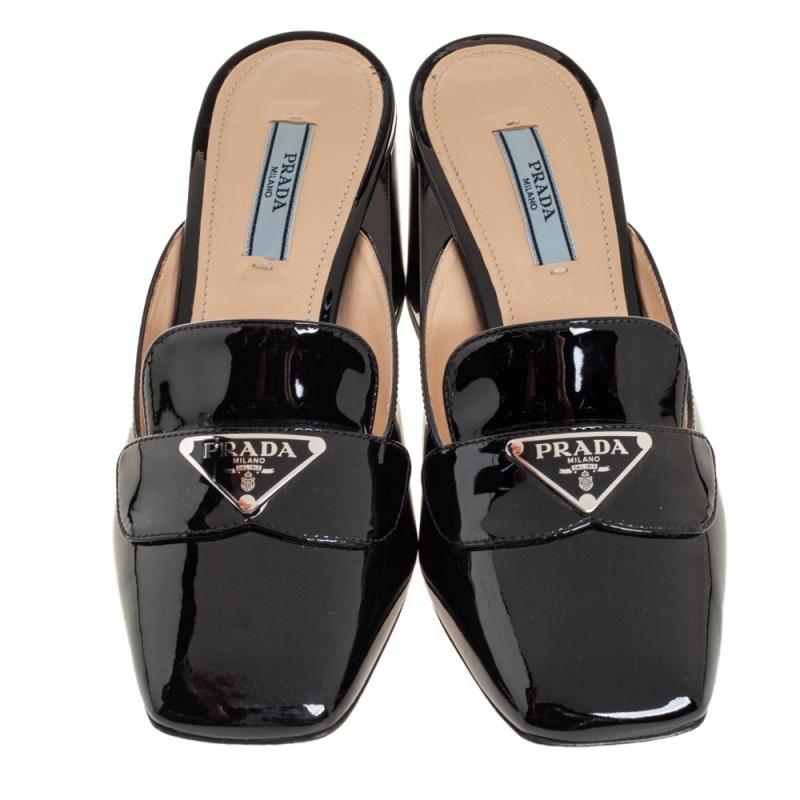 These glossy black-hued mules are made from premium quality patent leather and reflect comfortable fashion and classic style. Designed to perfection, this pair from the leading luxury house of Prada arrives like a loafer and is lifted on 8 cm block