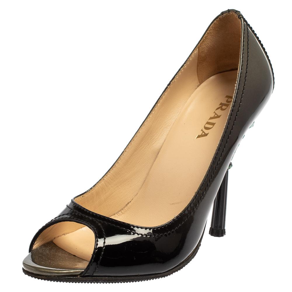 These fabulous pumps from Prada will lend a luxurious appeal to your looks. They are crafted from patent leather in black and feature peep-toes and neat stitching throughout. They come equipped with comfortable leather-lined insoles and stand tall