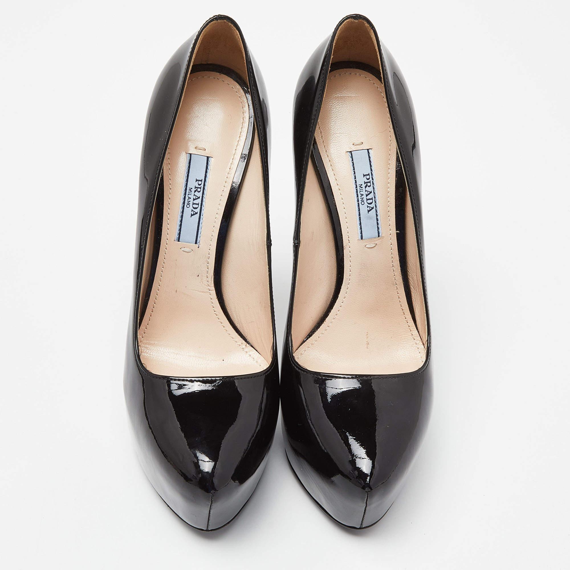 These pumps from Prada are meant to be a loved choice. Wonderfully crafted from patent leather, and balanced on platforms and 15 cm heels, the black pumps are high in both style and comfort.

