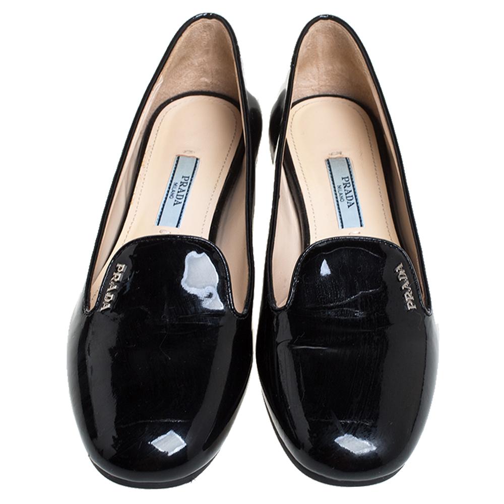 Keep it casual and chic in these black slip-on loafers from Prada. They come crafted from patent leather and feature round toes and brand logo detailing on the vamps. They are complete with comfortable leather-lined insoles and durable rubber