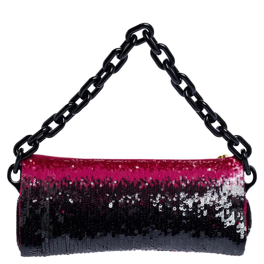 This clutch from Prada is designed with sequins. It brings the brand name on the front and a top zipper to secure the interior which is lined with satin. It comes held by a chain and is perfect for evenings.

