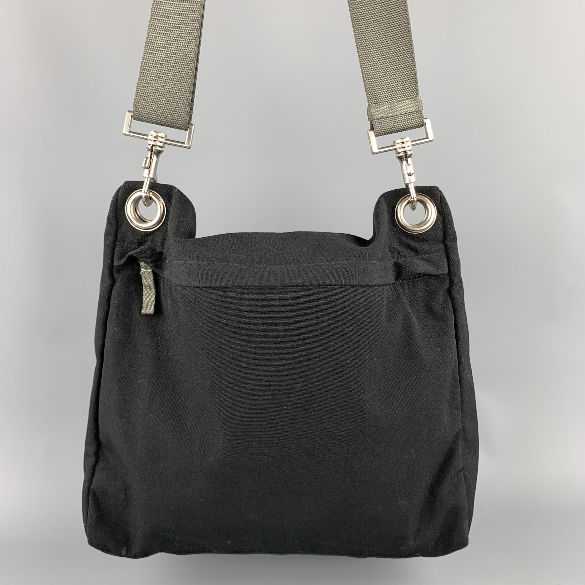 PRADA messenger handbag comes in a black canvas with a gray removable shoulder strap featuring a inner zipper pocket and a zip up closure. Made in Italy.

Very Good Pre-Owned Condition.

Measurements:

Length: 13 in. 
Width: 5 in. 
Height: 12 in.