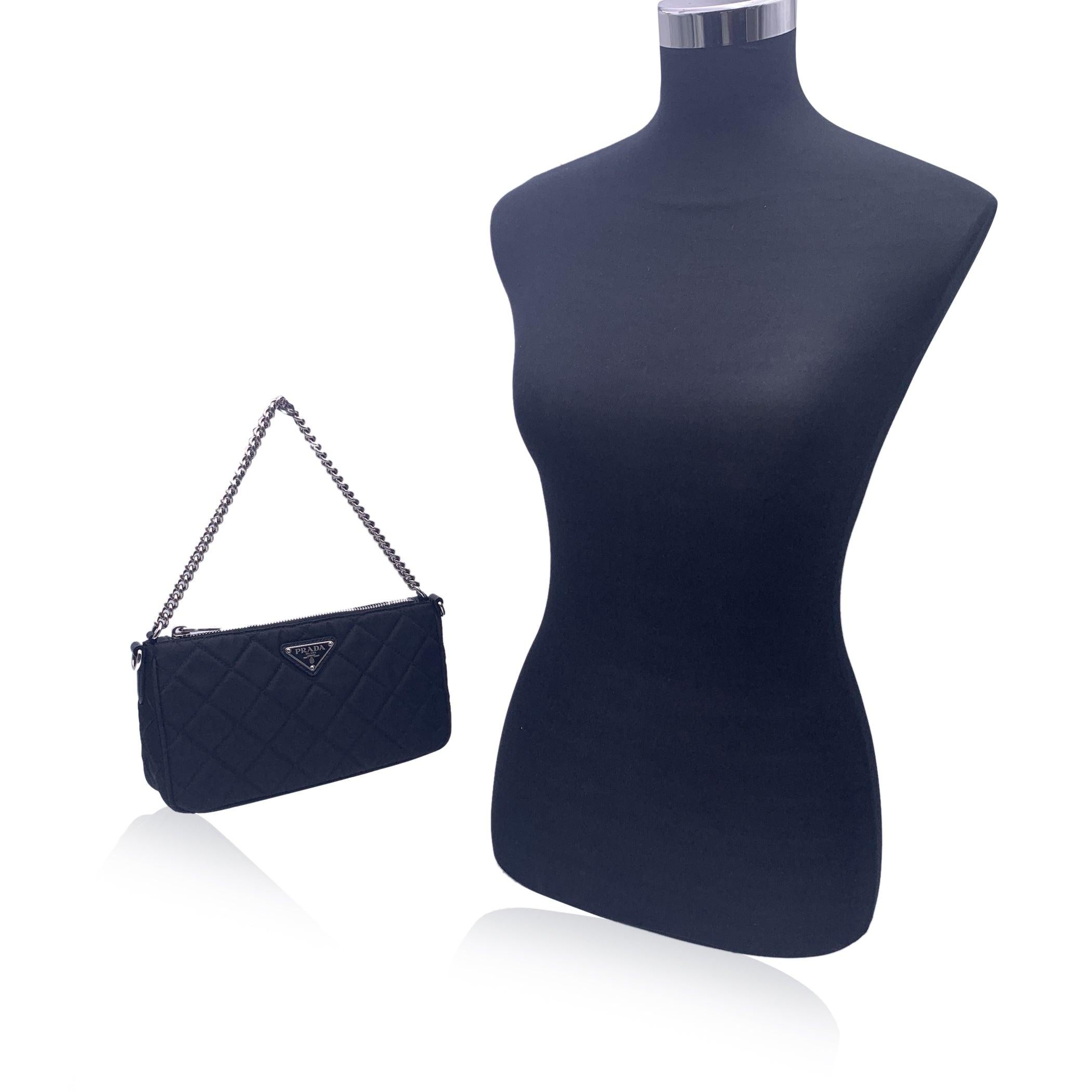 This beautiful Bag will come with a Certificate of Authenticity provided by Entrupy. The certificate will be provided at no further cost. PRADA black nylon quilted canvas shoulder bag, mod. 1BH026. Convertible design: it features a silver metal