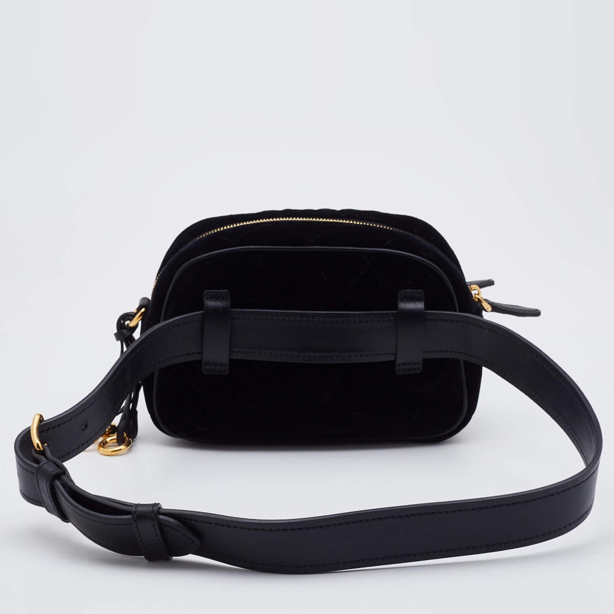 This Prada velvet & leather belt bag for women highlights convenient style in the best way. The bag has gold-tone ring details, a front brand logo, an adjustable belt strap, and an additional gold-tone chain.

