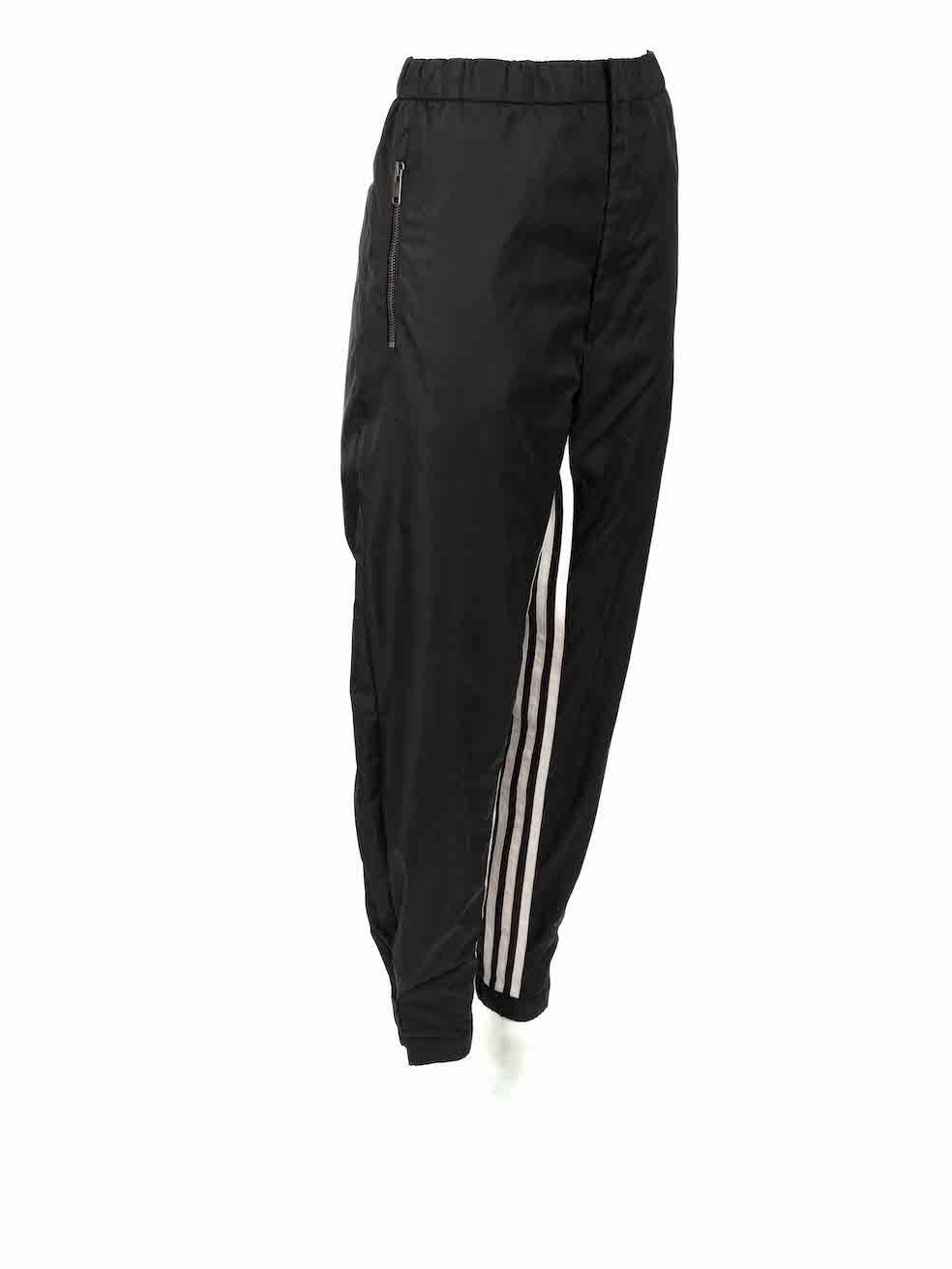 CONDITION is Very good. Hardly any visible wear to trousers is evident on this used Prada designer resale item.
 
 Details
 Black
 Re-nylon
 Track trousers
 High rise
 Front zip closure with clasp and button
 Elasticated waistband with drawstring
