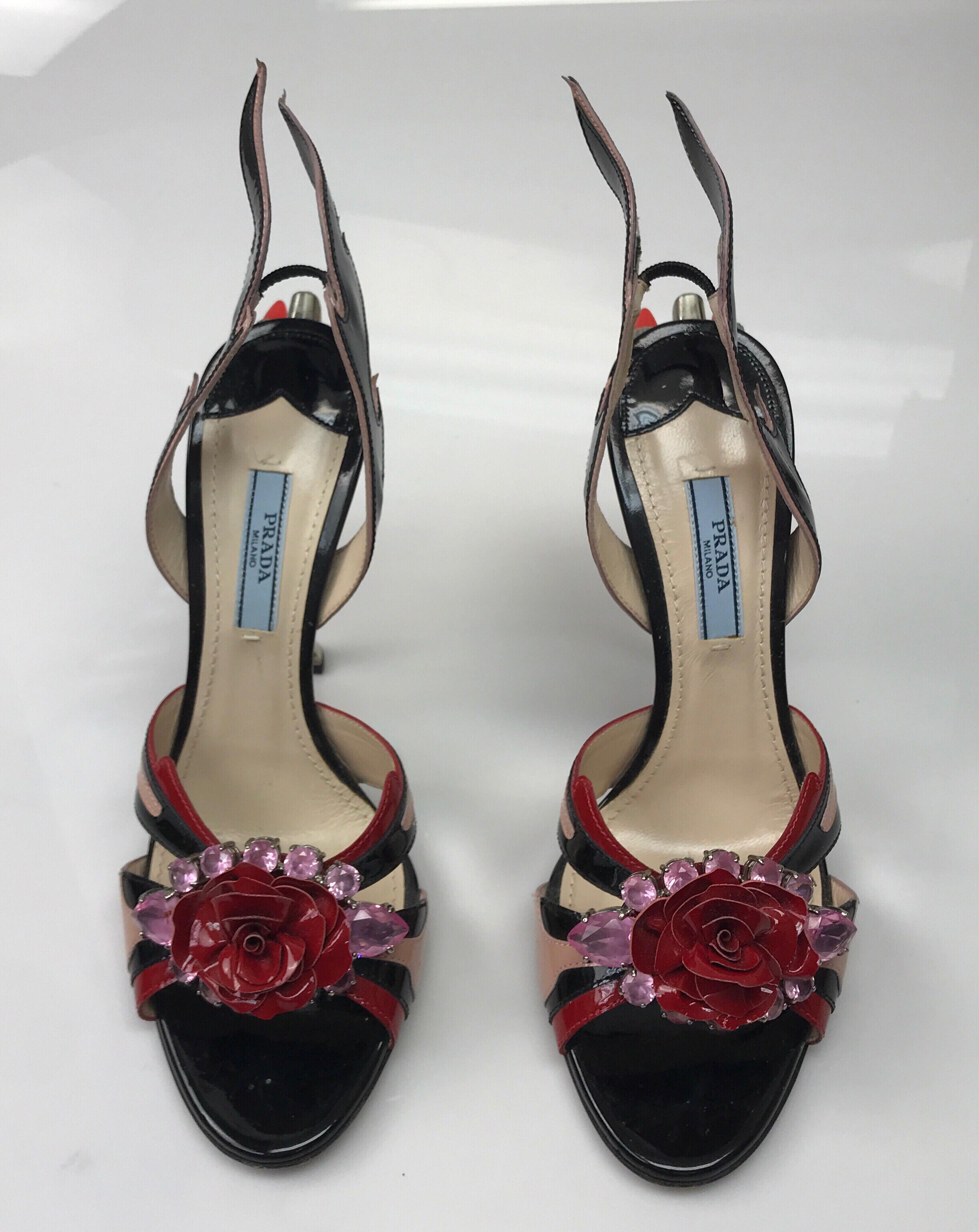 PRADA Black & Red Couture Jeweled Taillight Sandal-37.5. These beautiful Prada Couture heels are in excellent condition. They only show slight tarnishing at the top of the silver heel. They are made of black, red, and pink patent lather with pink