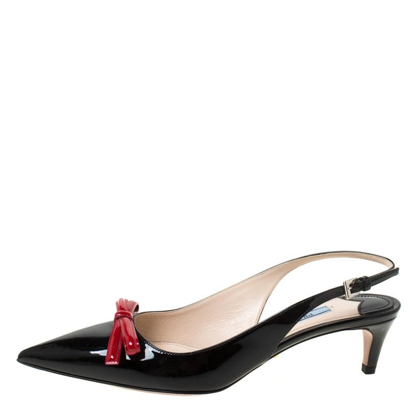 These black sandals are the epitome of elegance and poise. From the fashion house of Prada, they are crafted from patent leather and feature pointed toes, bow details on the vamps and slingback straps. The insoles are leather lined and carry the