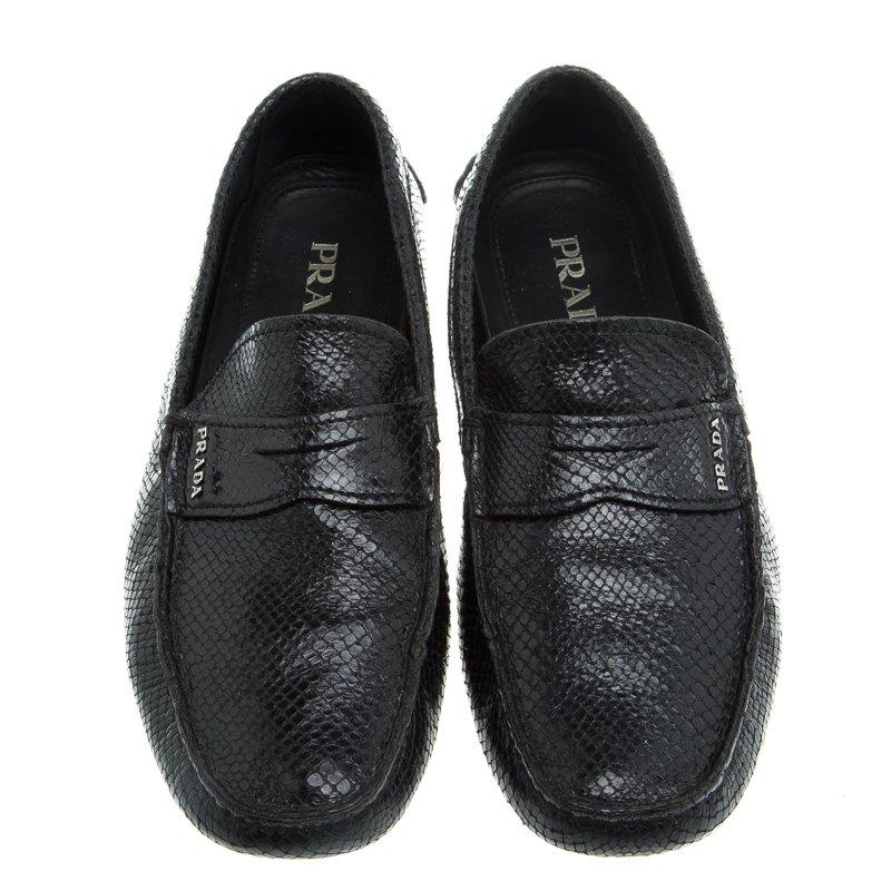Stylish and super comfy, this pair of loafers by Prada will make for a great addition to your shoe collection. The exterior of the shoes has been crafted from reptile leather and styled with a logo-accented Penny keeper strap. Leather interiors and