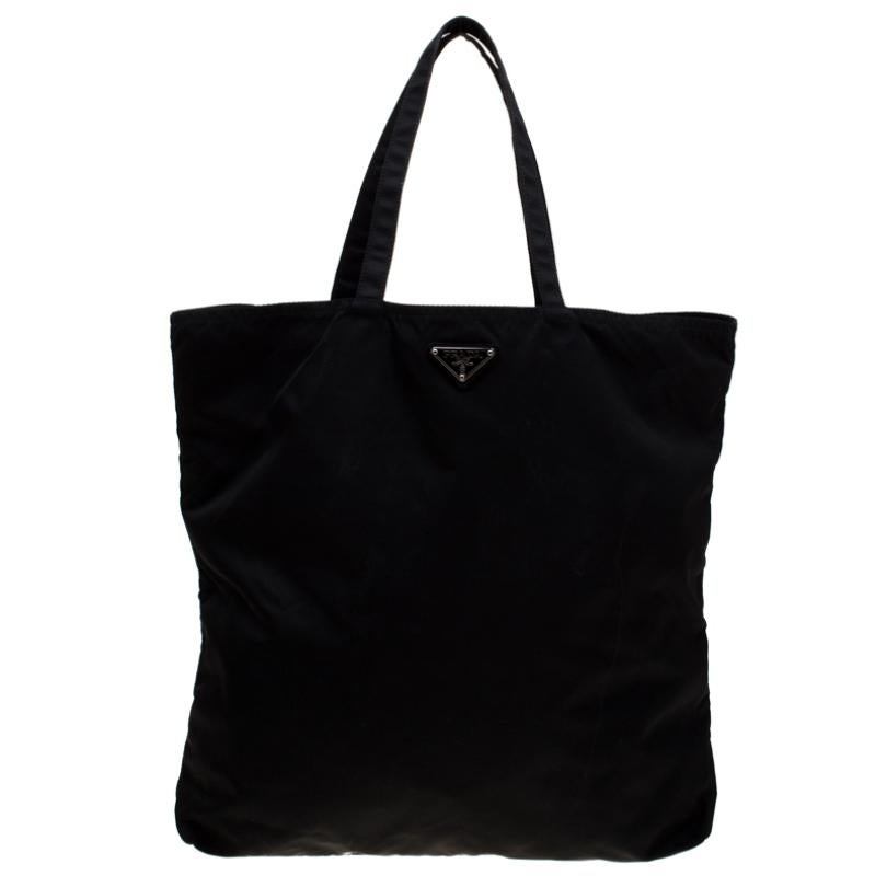 Do you know what would be the perfect tote to swing for your daily errands or sprees? This one here from Prada. It is perfect! Crafted from black nylon, the bag has a robot detail on the front, two handles and a spacious interior.

Includes: The