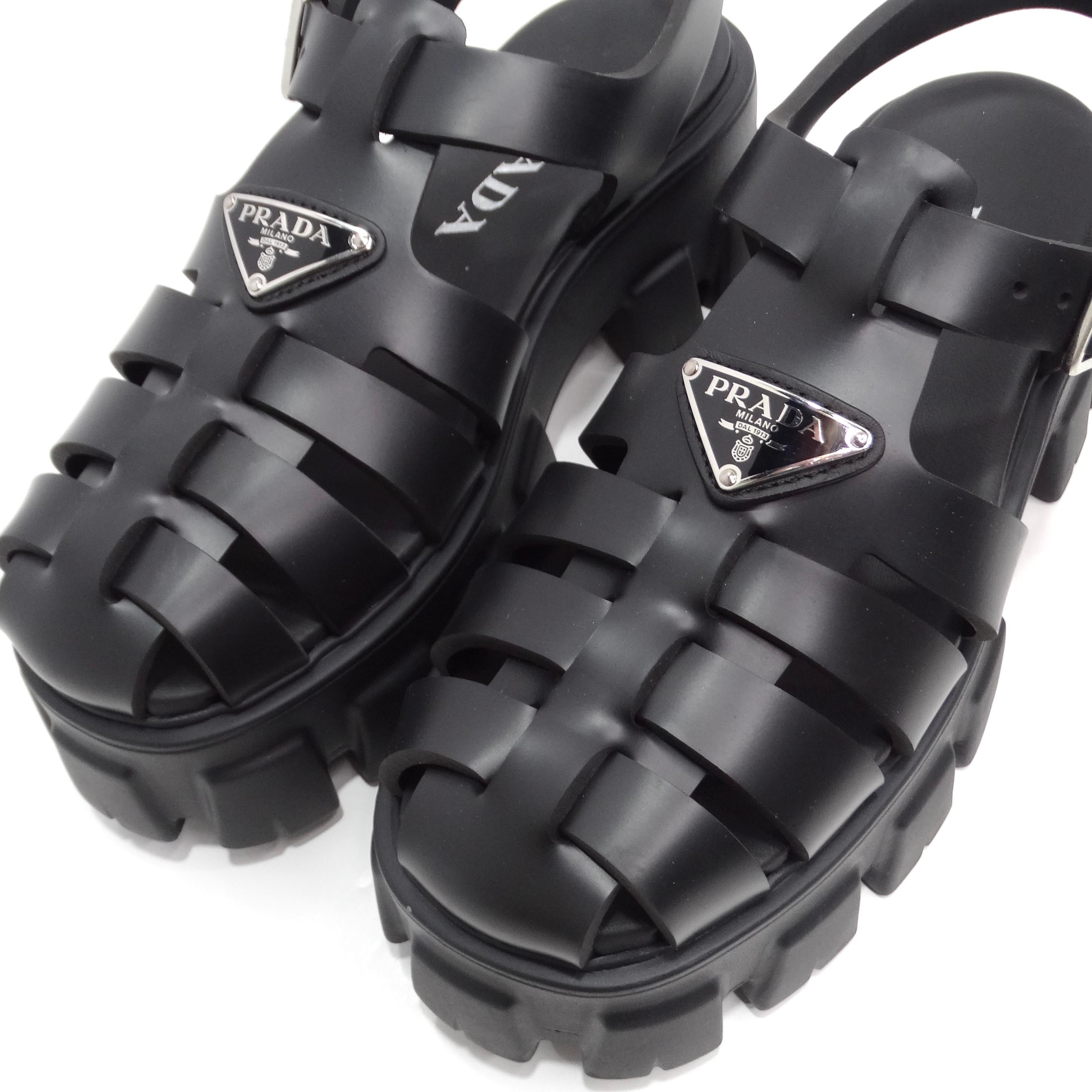 The Prada Black Rubber Caged Slingback Platform Sandals are a bold and contemporary take on retro beach footwear, combining style with functionality. These platform sandals feature a chunky yet lightweight Monolith sole that provides both comfort