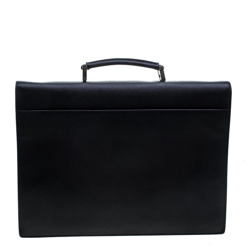 This Prada briefcase brings such a fantastic shape that you're sure to look fashionable whenever you carry it. It has been crafted from Saffiano Cuir leather and designed with a top handle and a flap with a combination lock to secure the well-sized