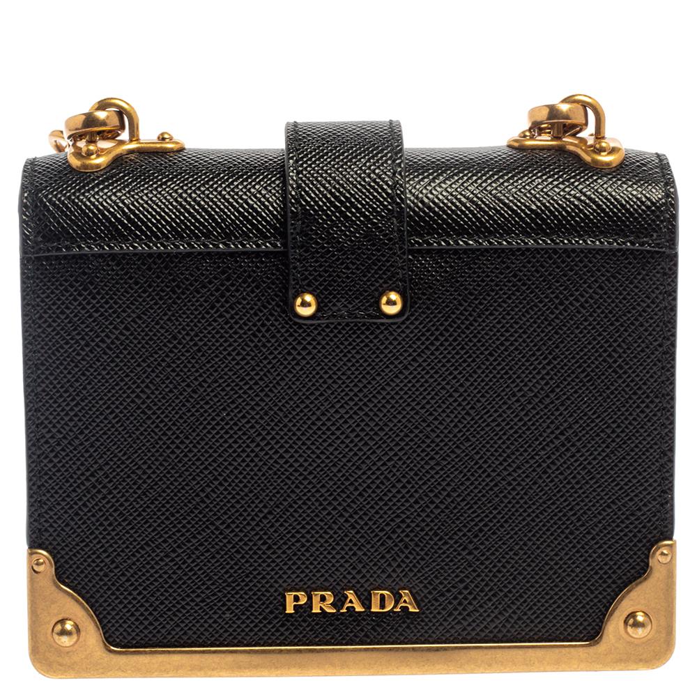 Impeccably designed in Saffiano leather, this Cahier crossbody bag by Prada is the perfect one for the modern fashionista. Lined with fine leather, this black-hued bag delivers trendy looks as well as functionality. It has a front adorned with