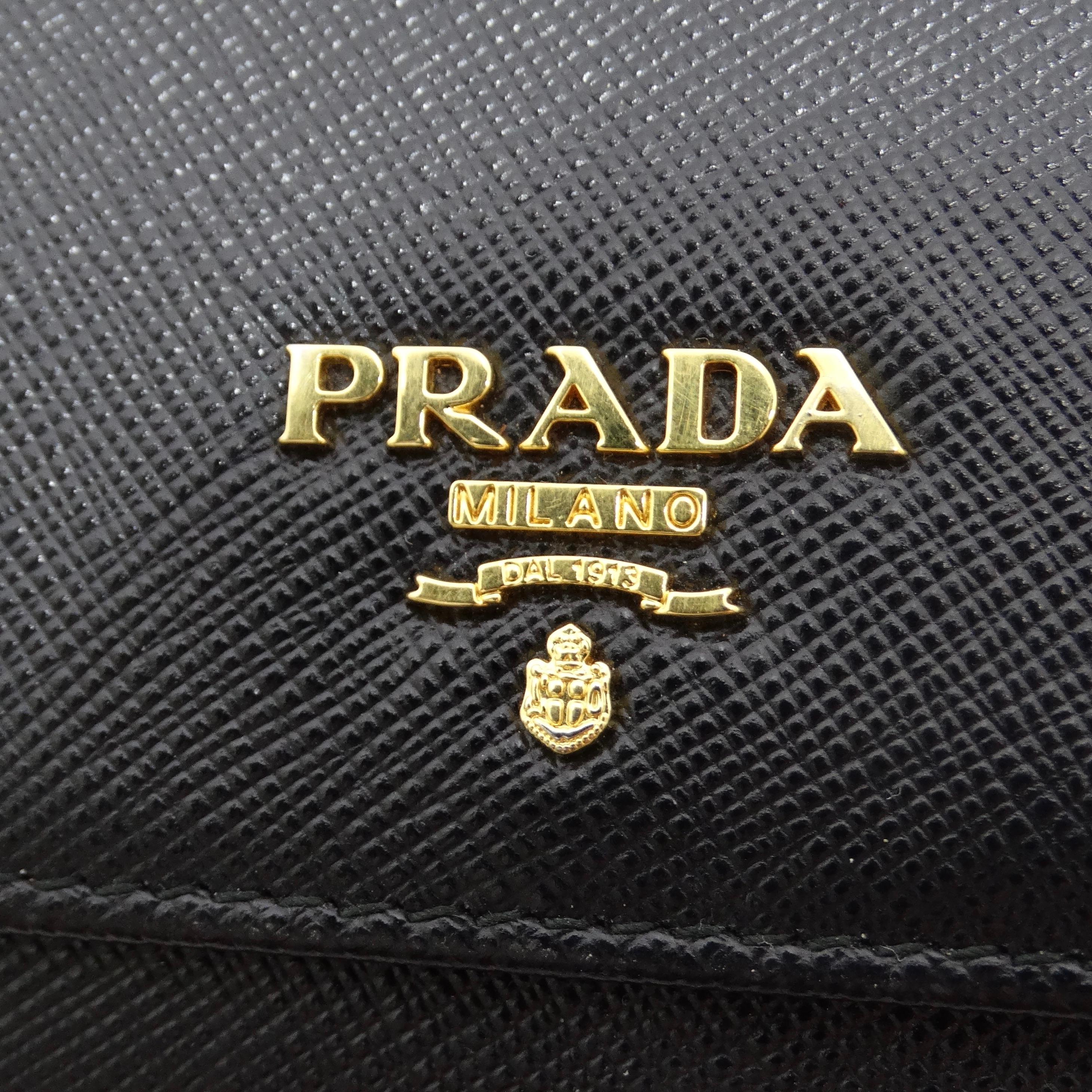 Introducing the Prada Black Saffiano Leather Continental Wallet—a timeless accessory that seamlessly combines luxury with practicality. Crafted in Italy, this wallet is not just an everyday essential; it's a sophisticated statement piece. Imagine