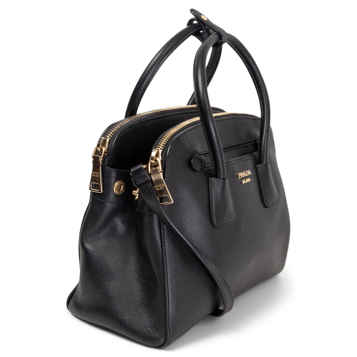 100% authentic Prada Double Zipper Tote in black Saffiano Lux leather and silver-tone hardware. Designed with two outside slip pockets and zipper pockets. The middle main compartment opens with a push-button. Lined in black logo nylon and leather