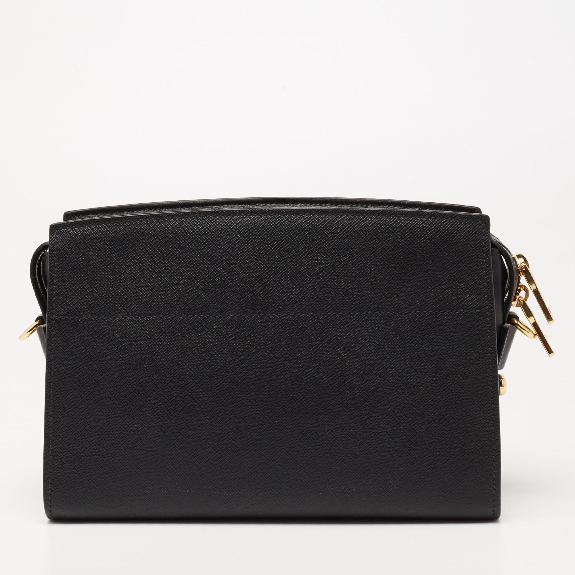 This Esplanade bag by Prada will be a fine companion for work lunches and outings. This chic black bag is brilliantly fashioned and spaciously sized. The Saffiano leather used for making it assures durability while the brand name on the front adds a