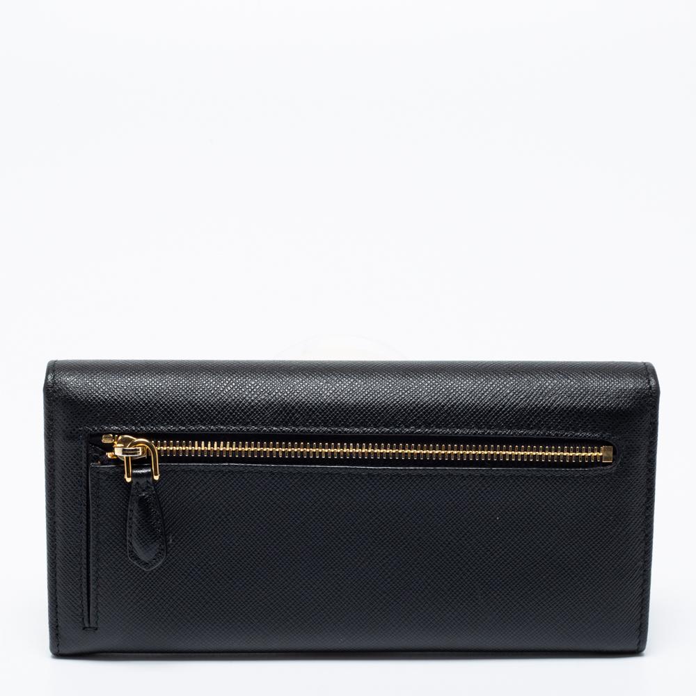 This continental wallet from the House of Prada will offer function with a hint of luxury. It is designed using black Saffiano leather and gold-toned hardware. The branded flap opens to a leather-fabric interior.

Includes: Authenticity Card,