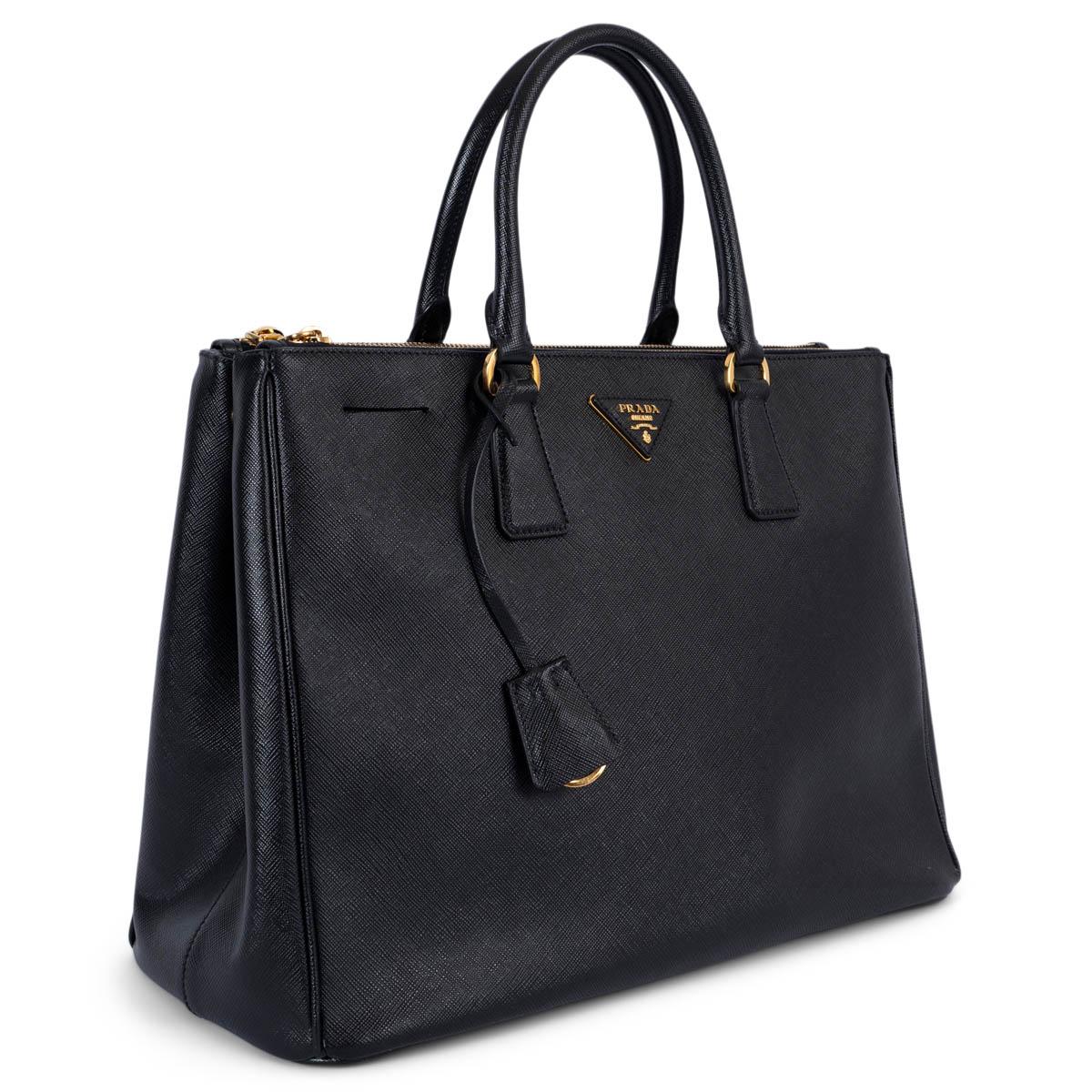 100% authentic Prada Large Galleria handbag in black Saffiano leather featuring gold-tone hardware. Lined in black monogram nylon and divided in three compartments, the two outside ones close with a zipper. The middle part has one zipper pocket